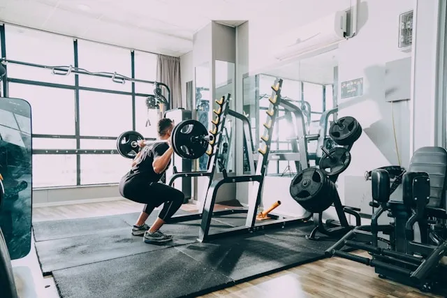 Man lifting a barbell in a gym during a strength training session