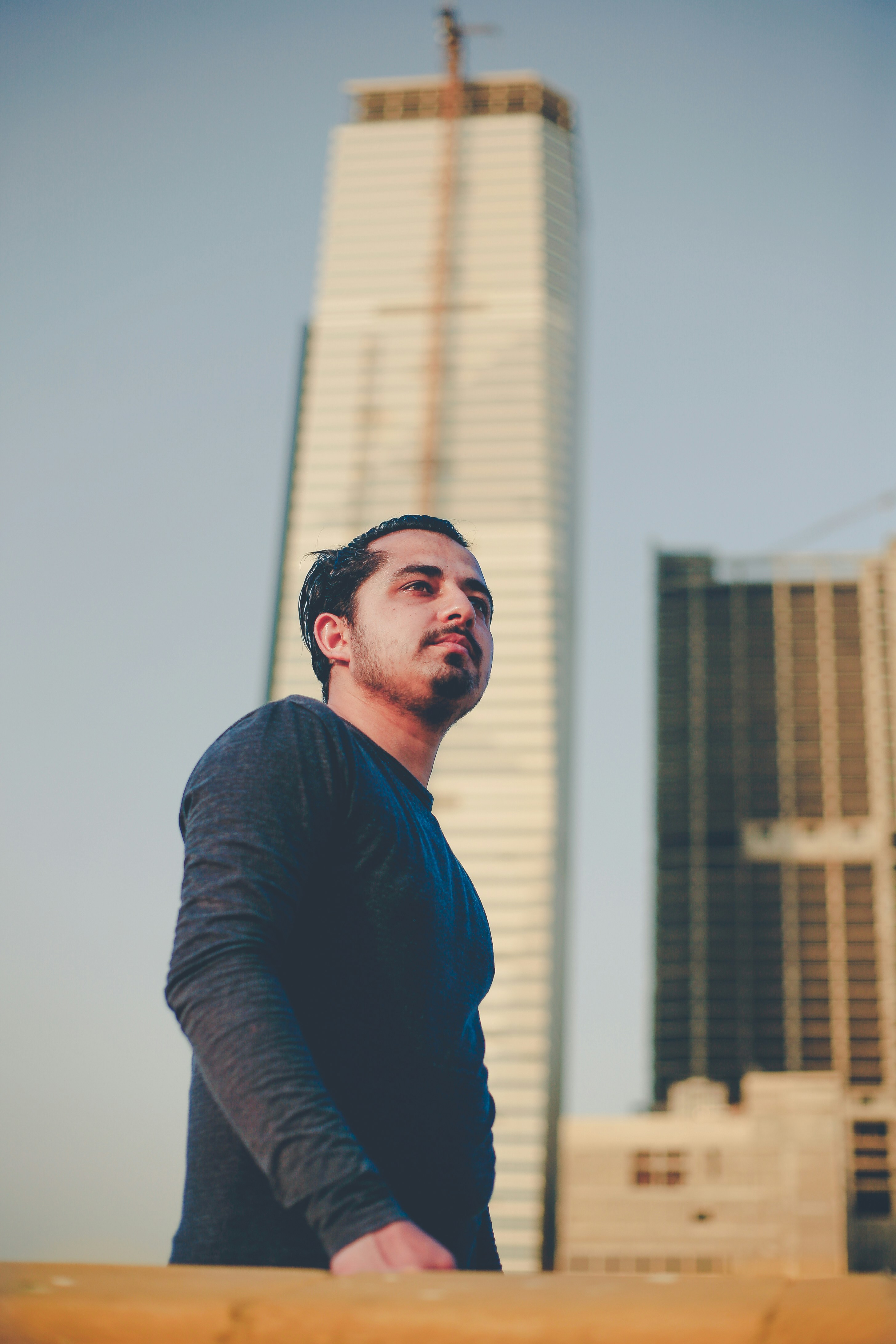 a man standing in front of a tall building