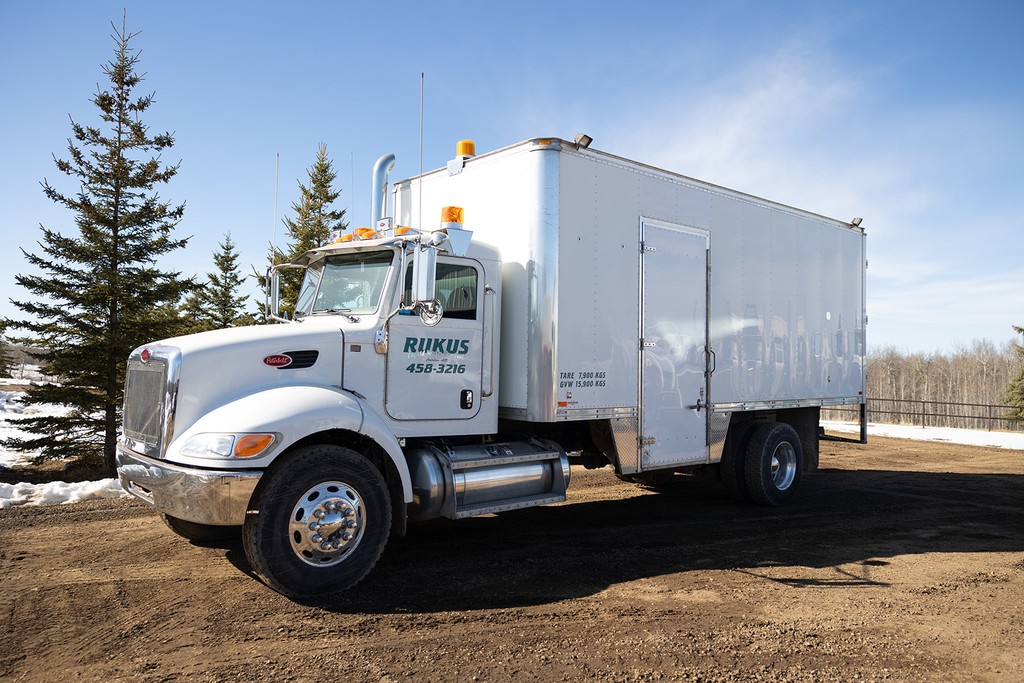 Rukus Liquid Waste Removal fleet of vacuum trucks and septic service vehicles parked on site in Calahoo, Alberta, serving Edmonton and surrounding areas with professional liquid waste management and septic pumping services.