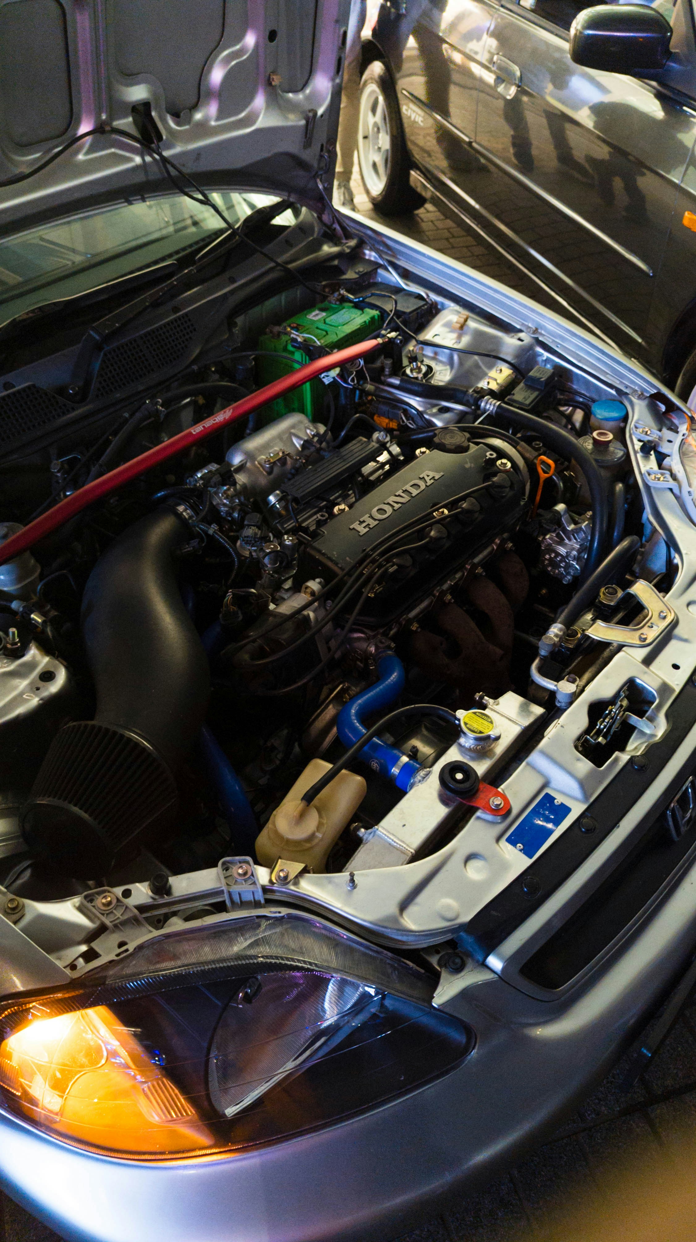 A modified honda engine under the hood.