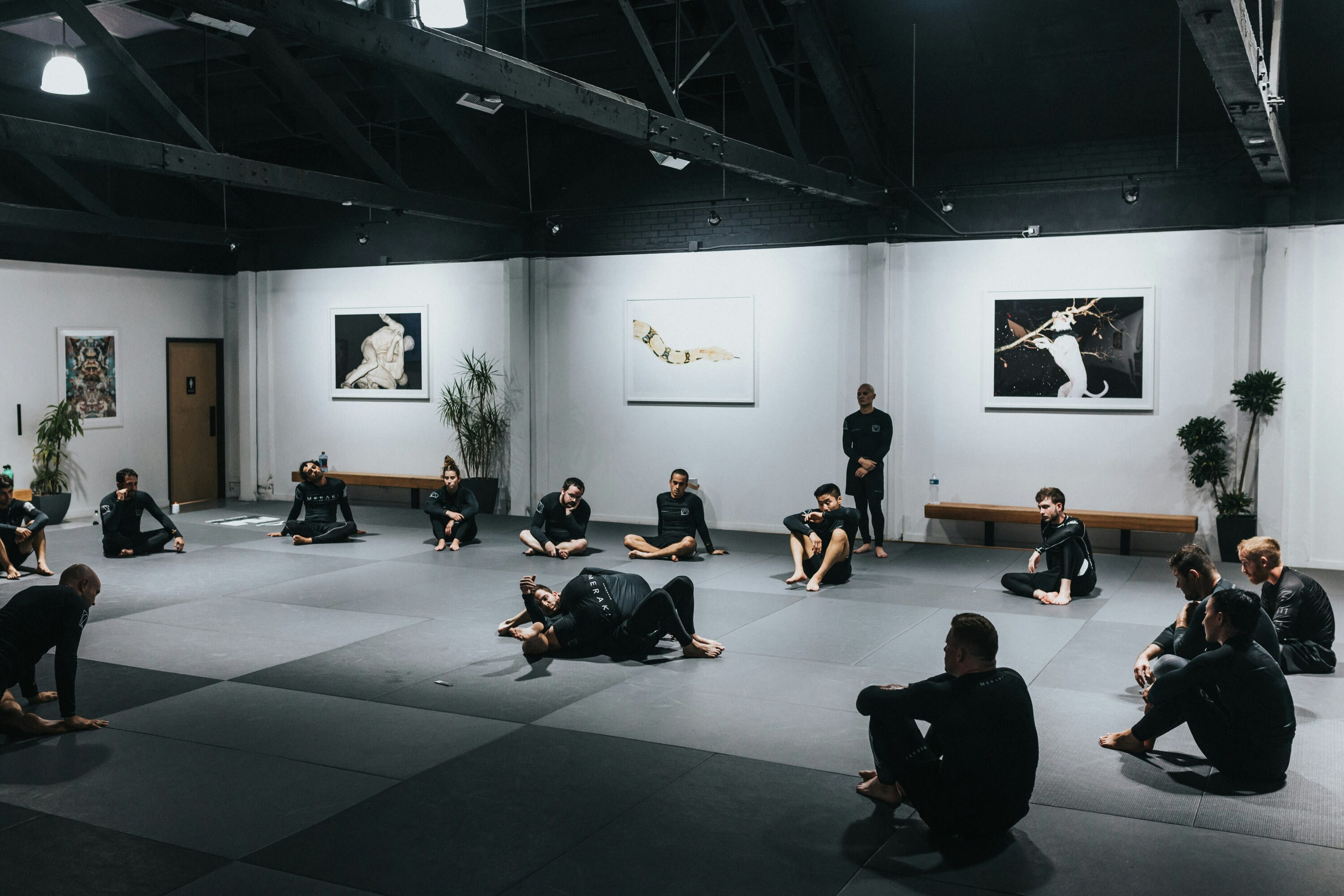 Martial arts students gathered on a training mat