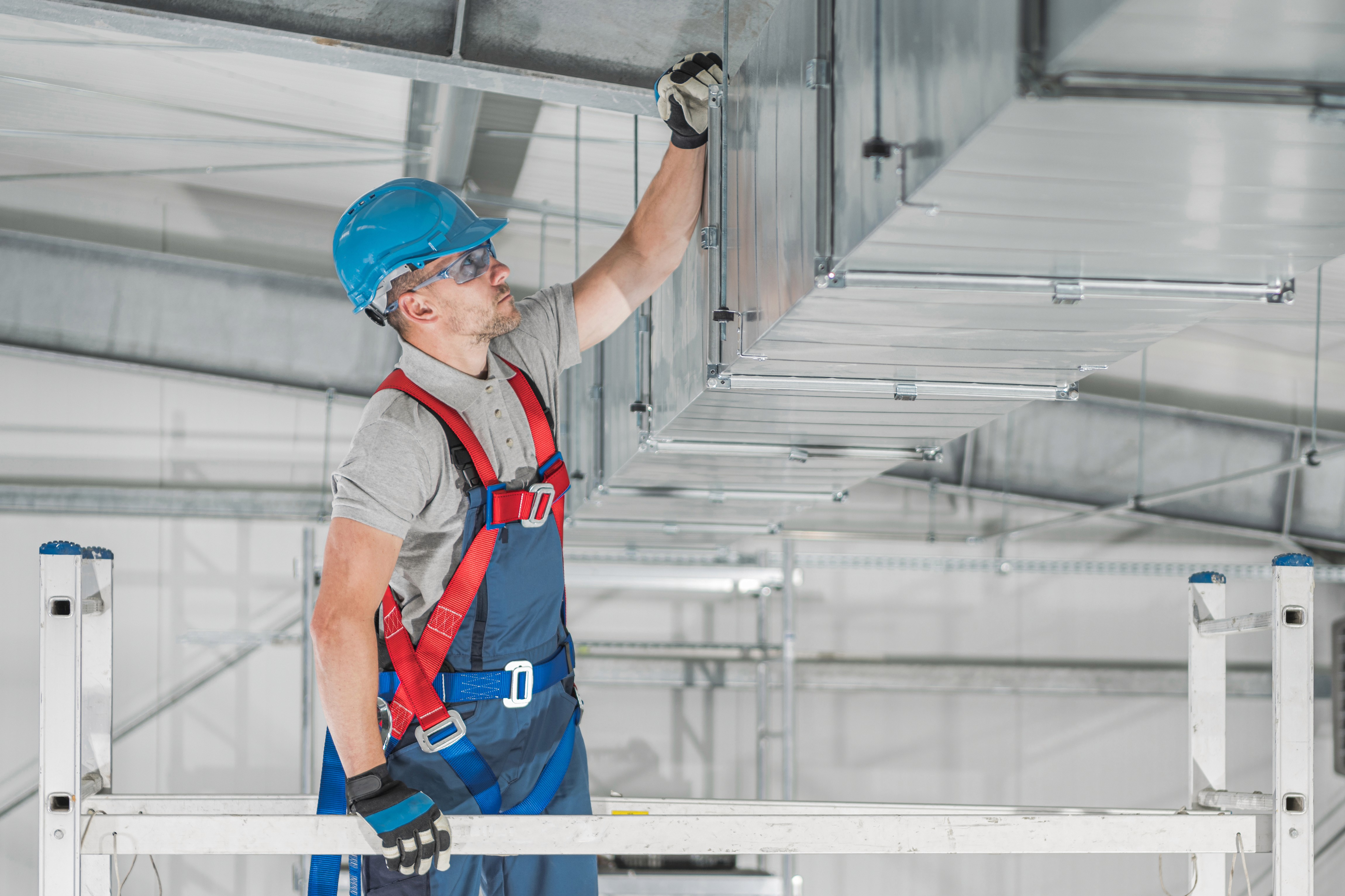 HVAC technician servicing residential ductwork to restore even airflow