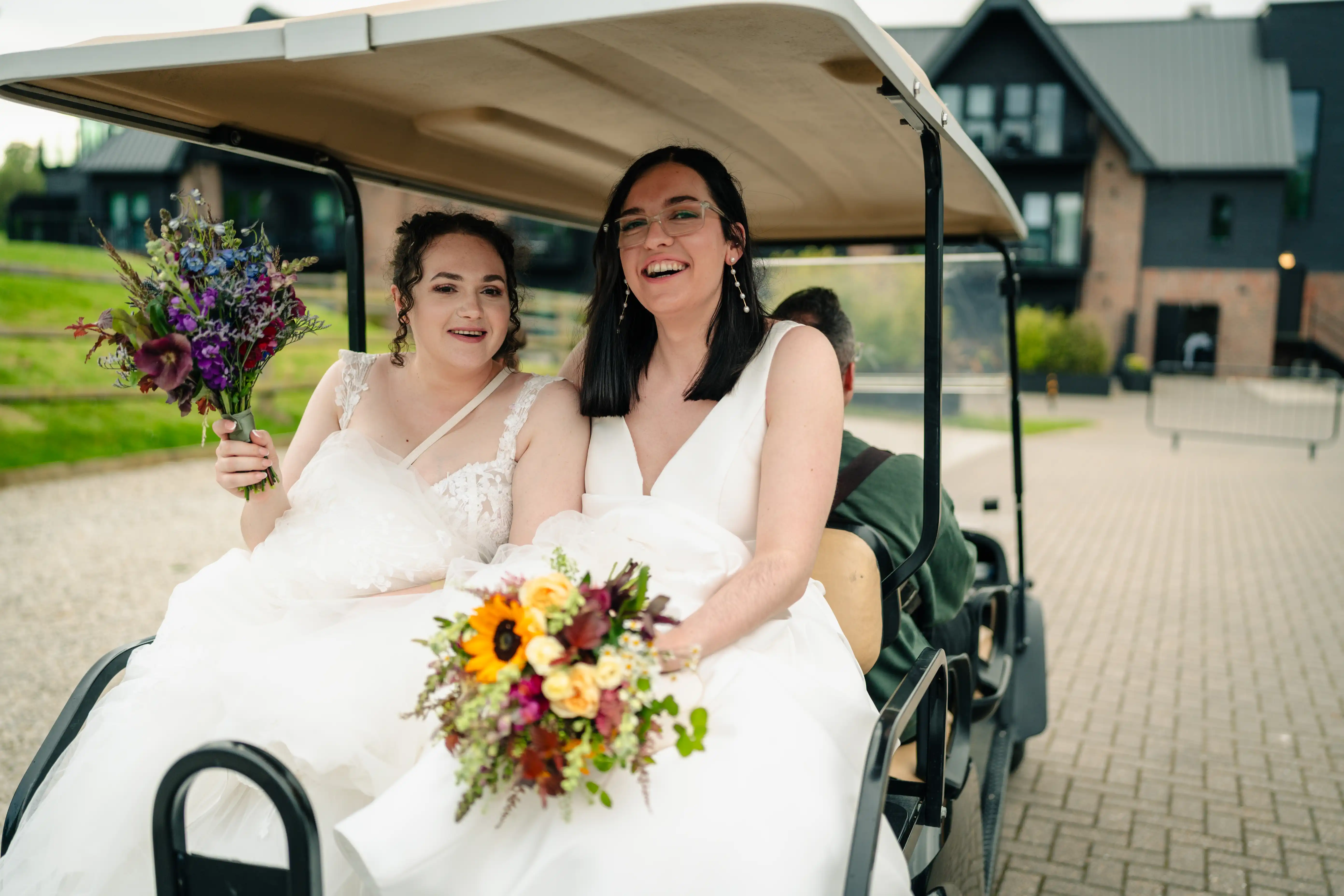 two brides in a golf cart