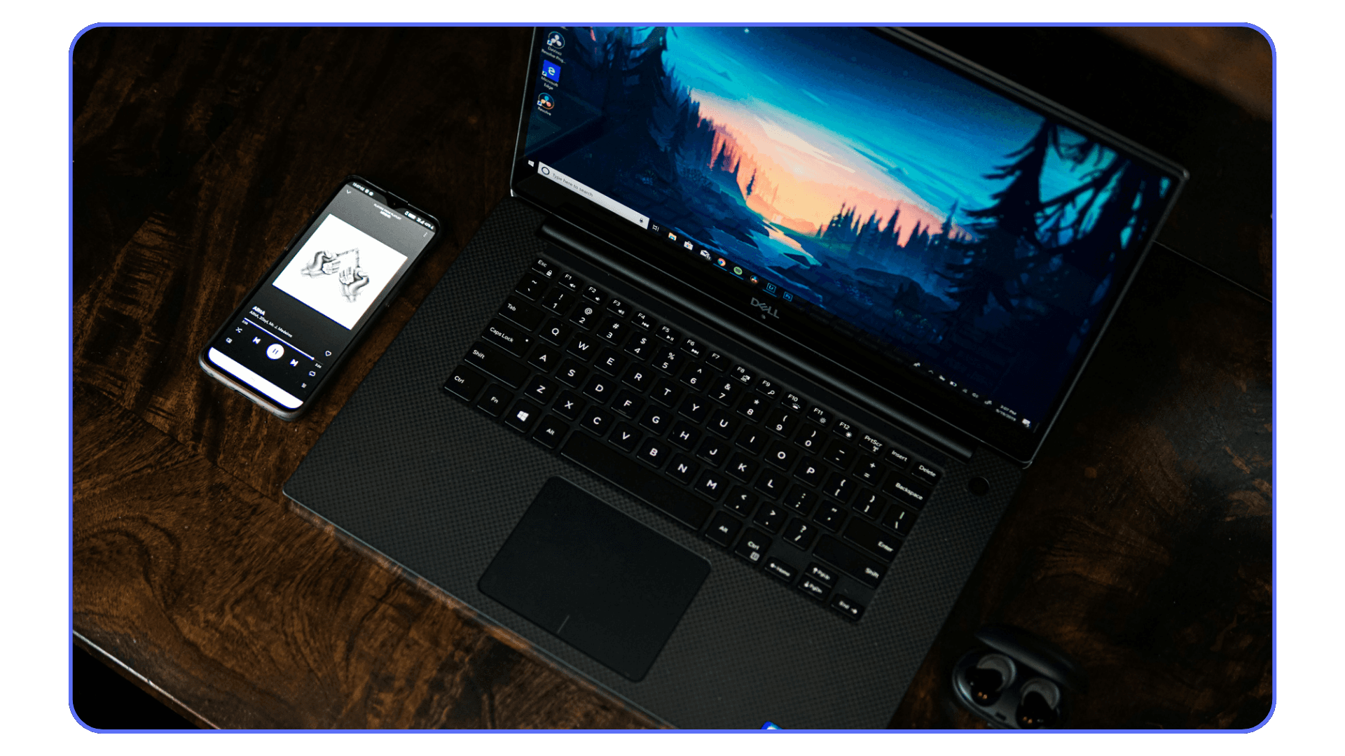 Dell XPS laptop on a desk with digital artwork displayed on screen