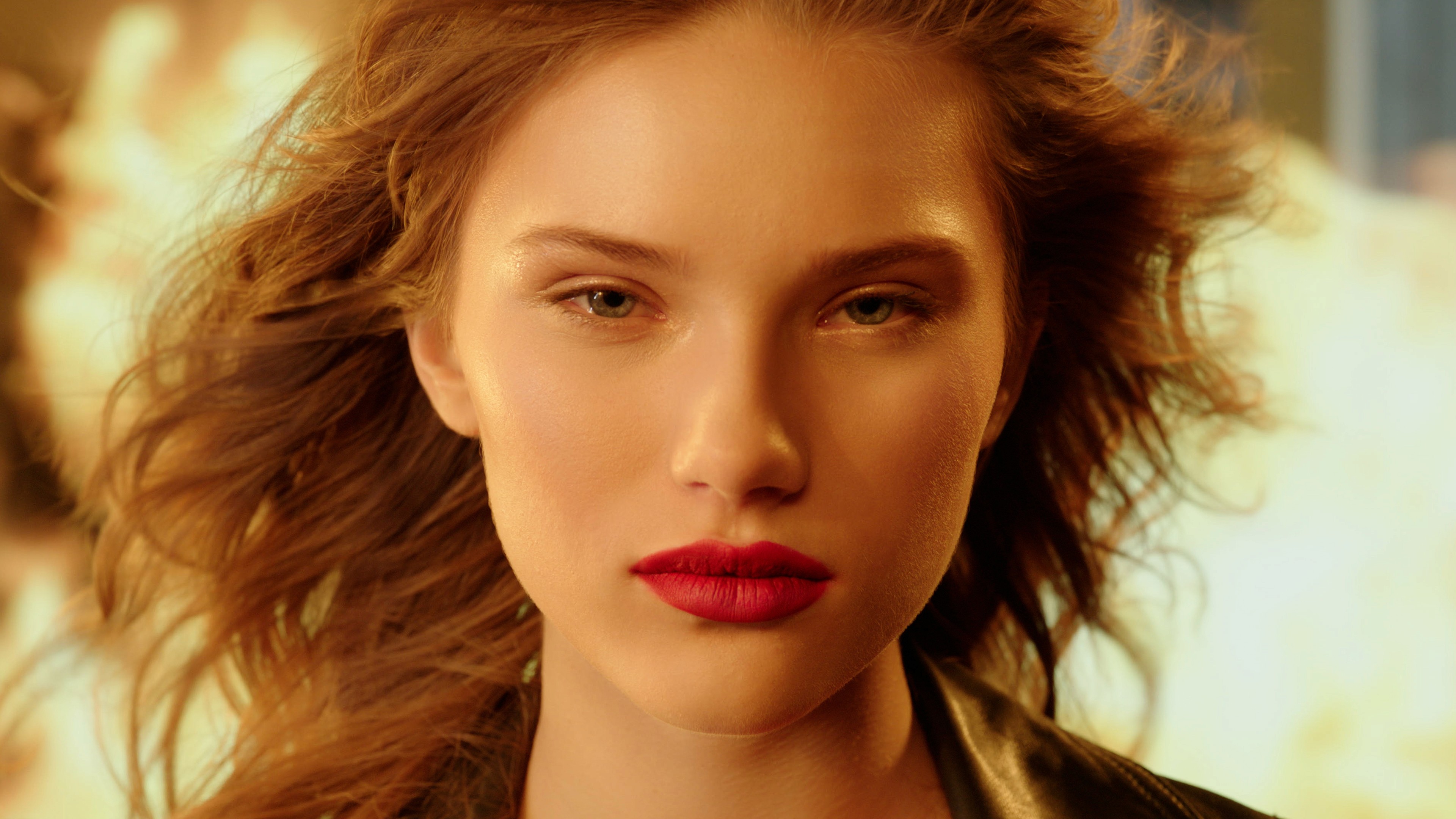 Close-up of a model with red lipstick against a fiery glow, from the Charlotte Tilbury spec film Love Flame