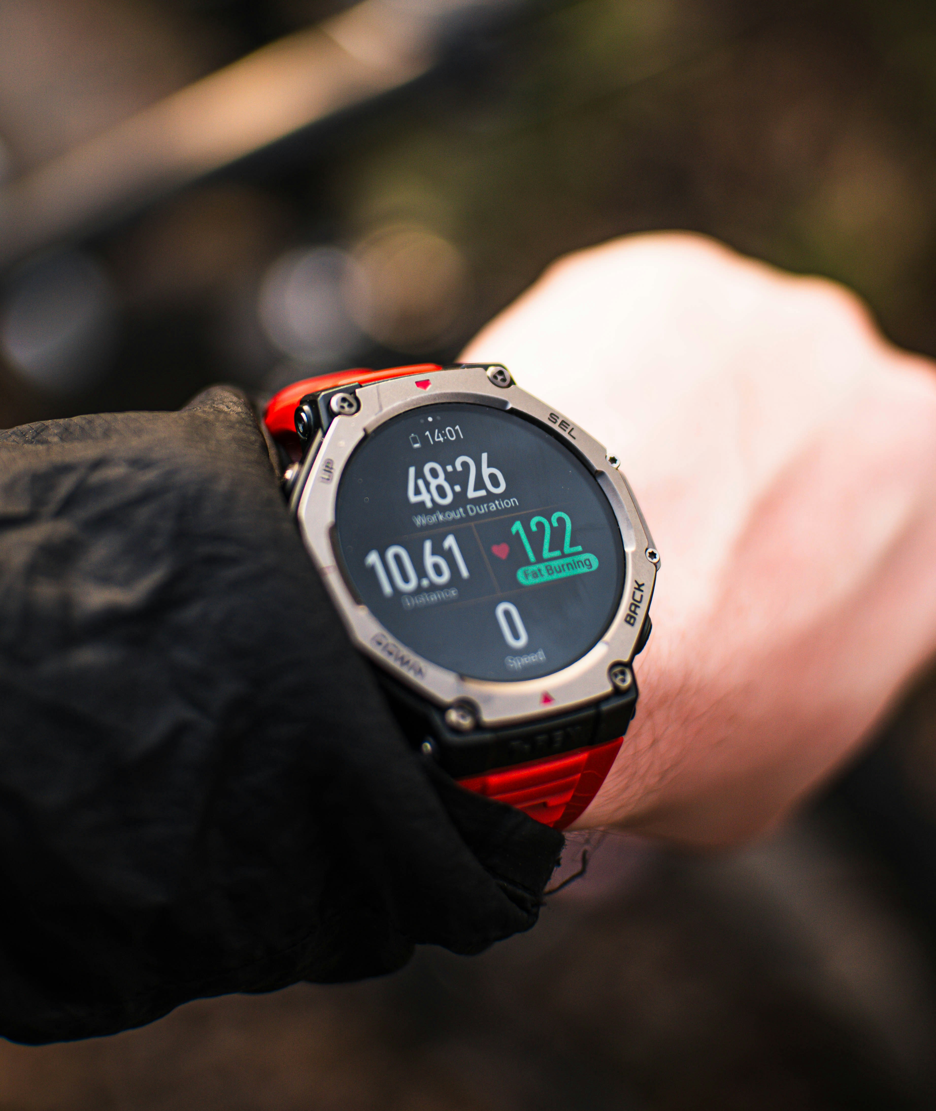 A person checks their fitness tracker during a workout.