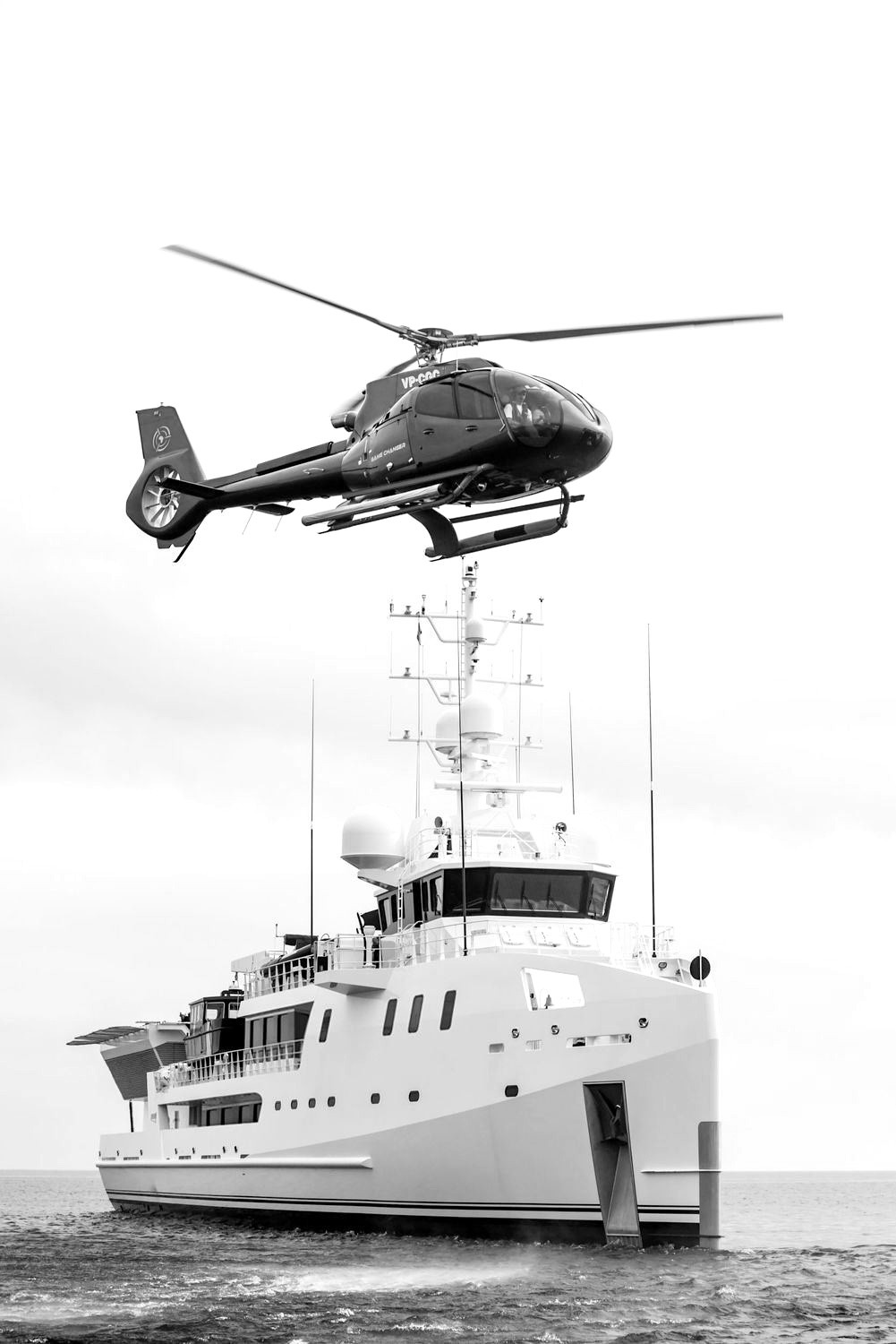 Helicopter flying over a superyacht