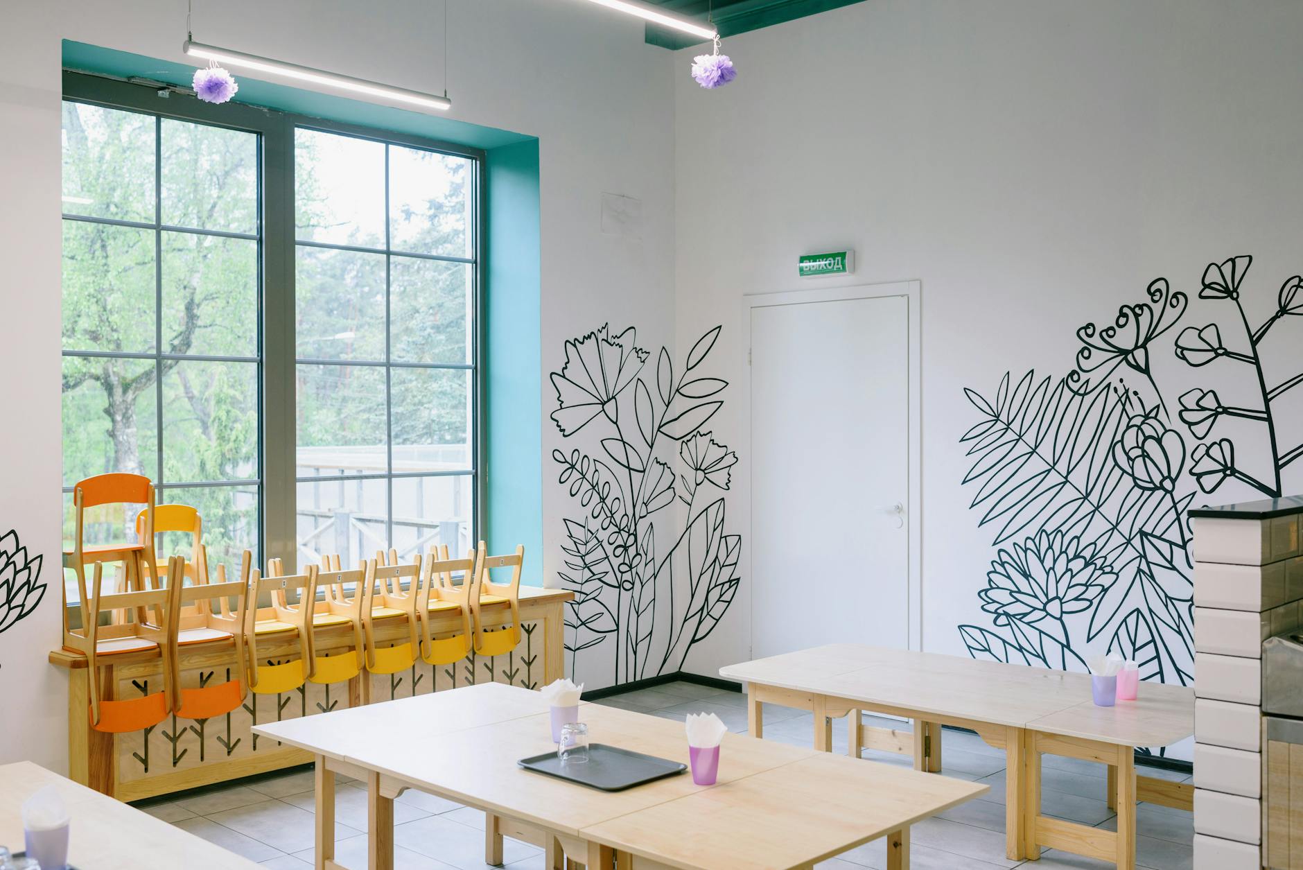 A diverse group of happy children wearing backpacks and walking into a bright, modern kindergarten class.