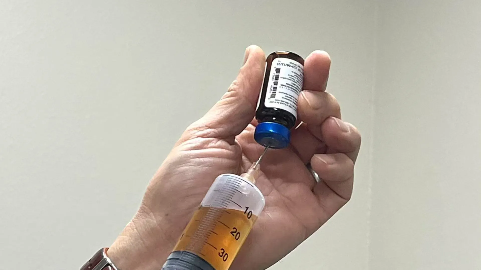 Drawing NAD therapy fluid from a medical vial.