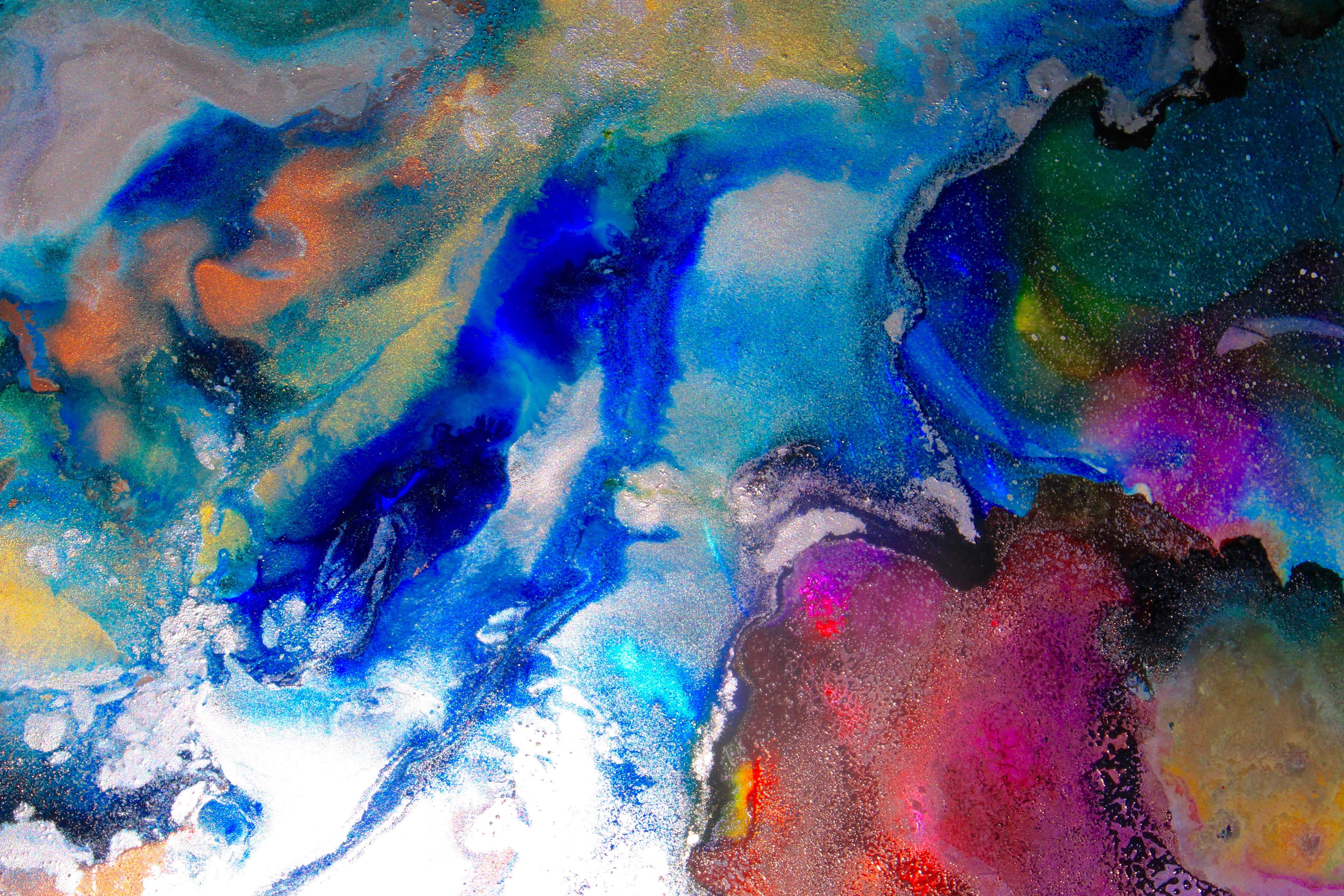 A soft-toned watercolor painting depicting a mountainous landscape with earthy hues and a flowing stream