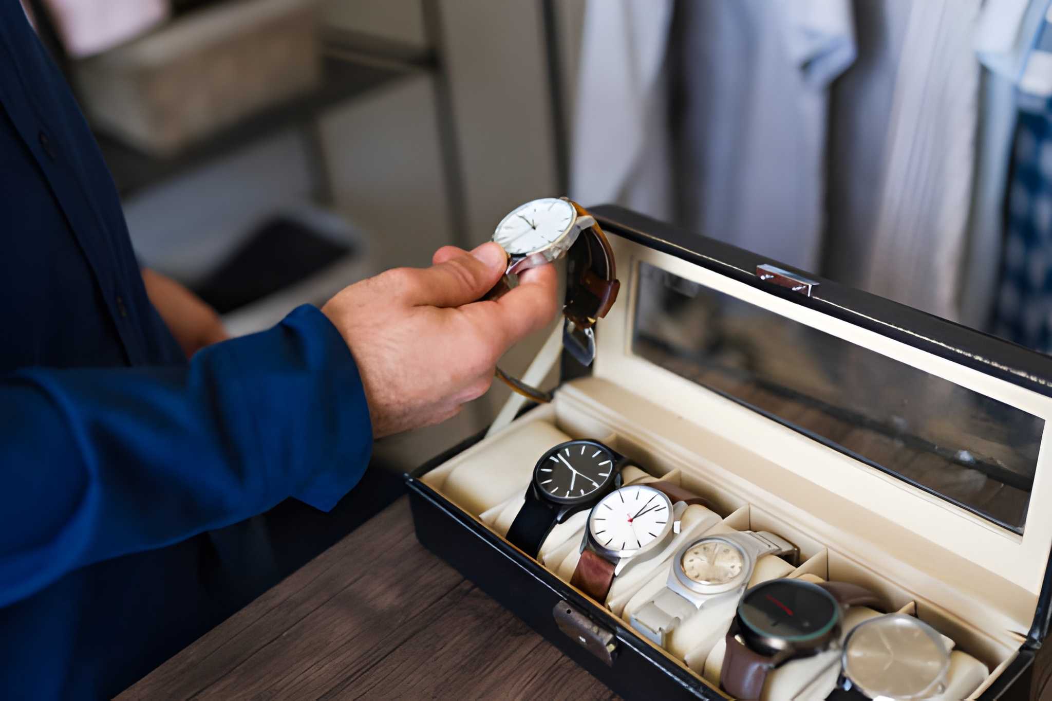 woman holding a phone and man looking at the phone. both are smiling