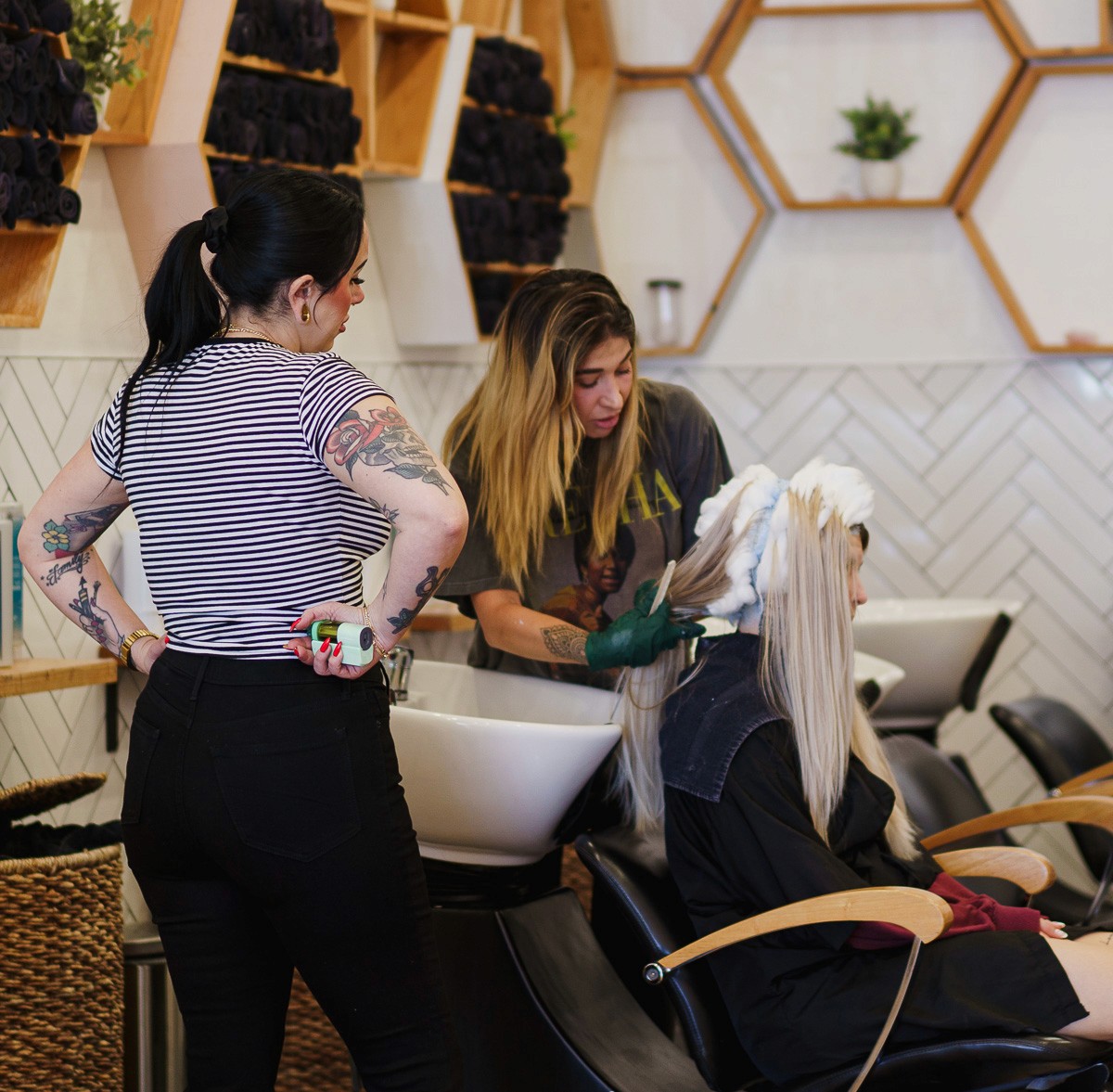 Del Sol Hair Studio stylists collaborating during color service Huntington Beach