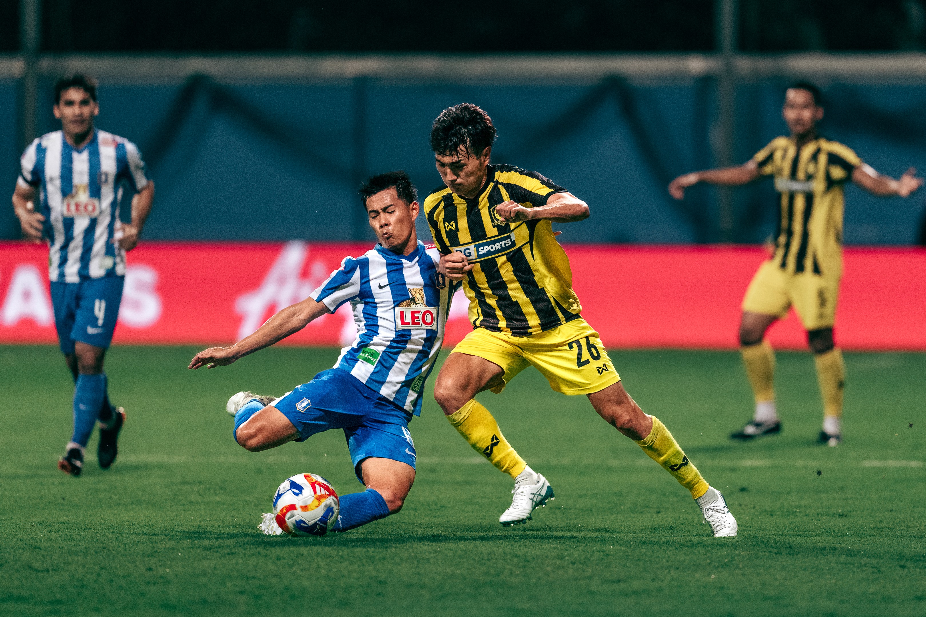 Sarach Yooyen challenges for a ball against Takeshi Yoshimoto during a match between Lion City Sailors and PKR Svay Rieng in the ASEAN Shopee Cup 2025/26 at Jalan Besar Stadium, 2025