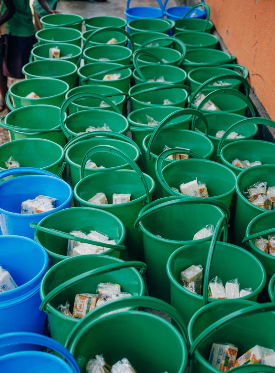 Buckets filled with SHE FOR SHE reusable pad products prepared for distribution.