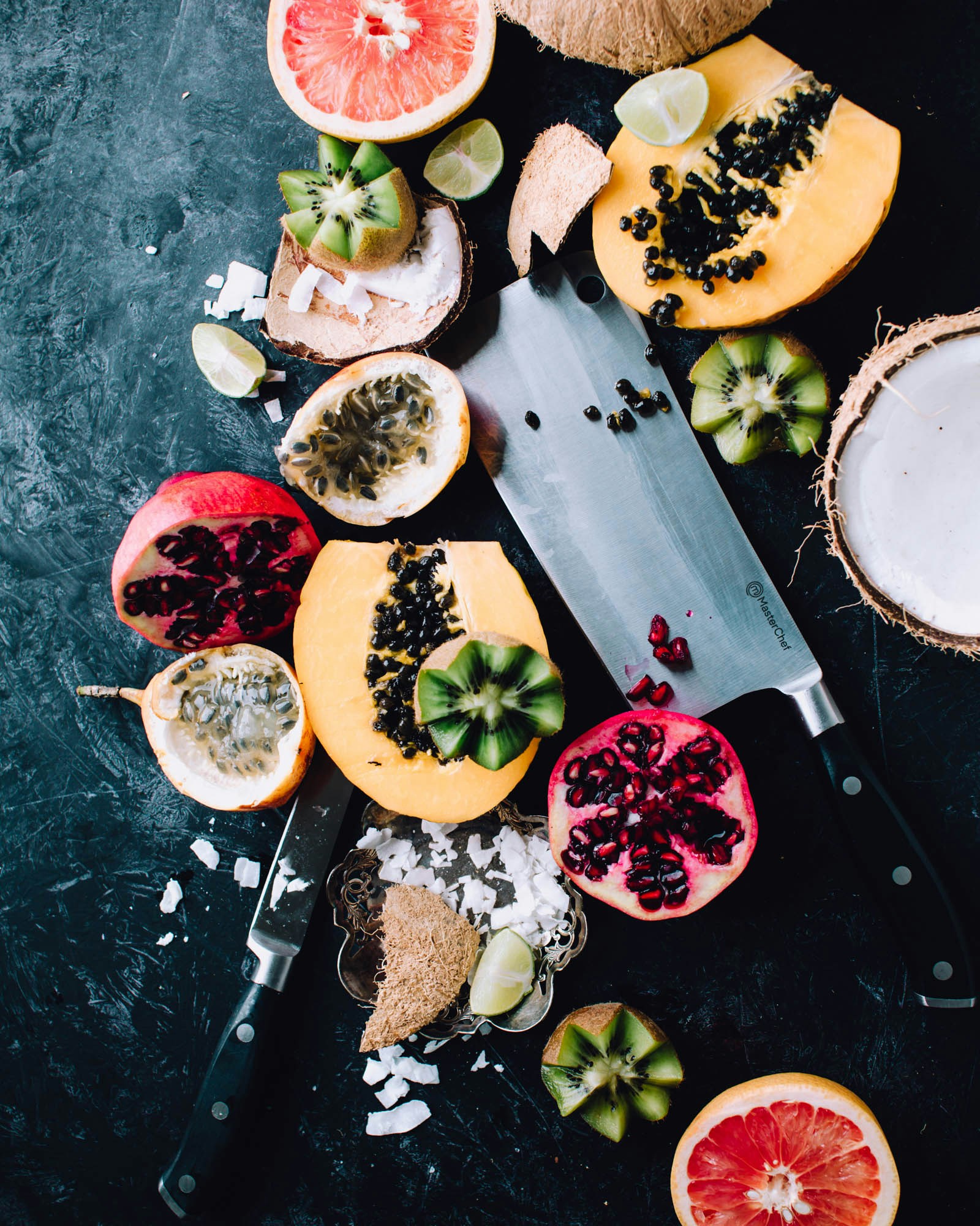 spread of tropical fruits cut open