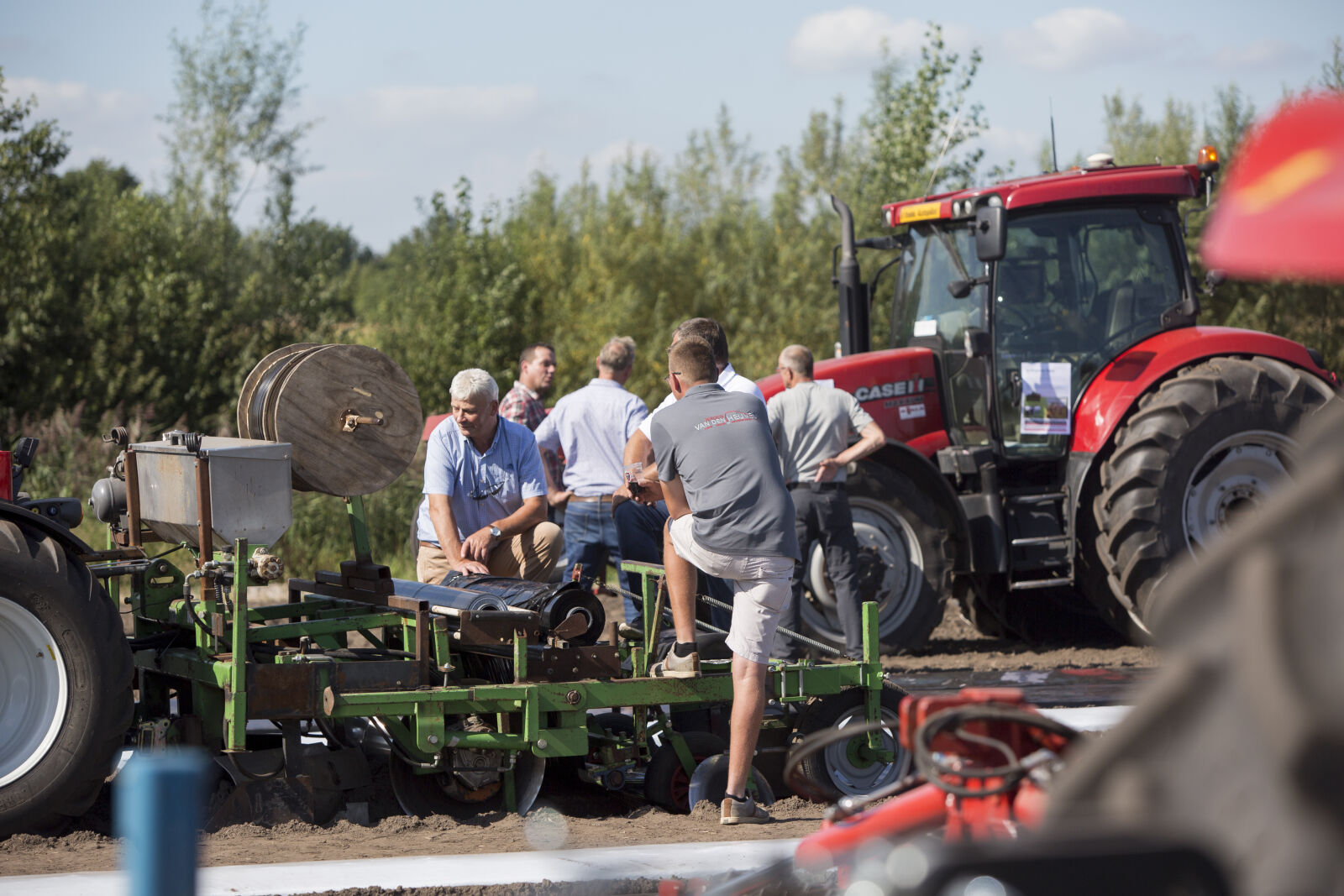 Two individuals are exercising in a hub, using fitness equipment with a focus on strength training.