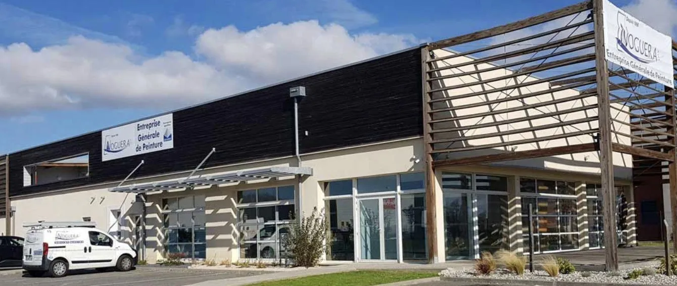 man sitting facing silver MacBook inside room