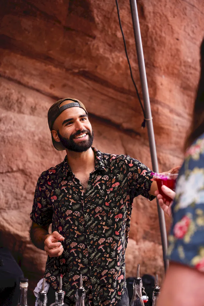 Bartender handing off a cocktail