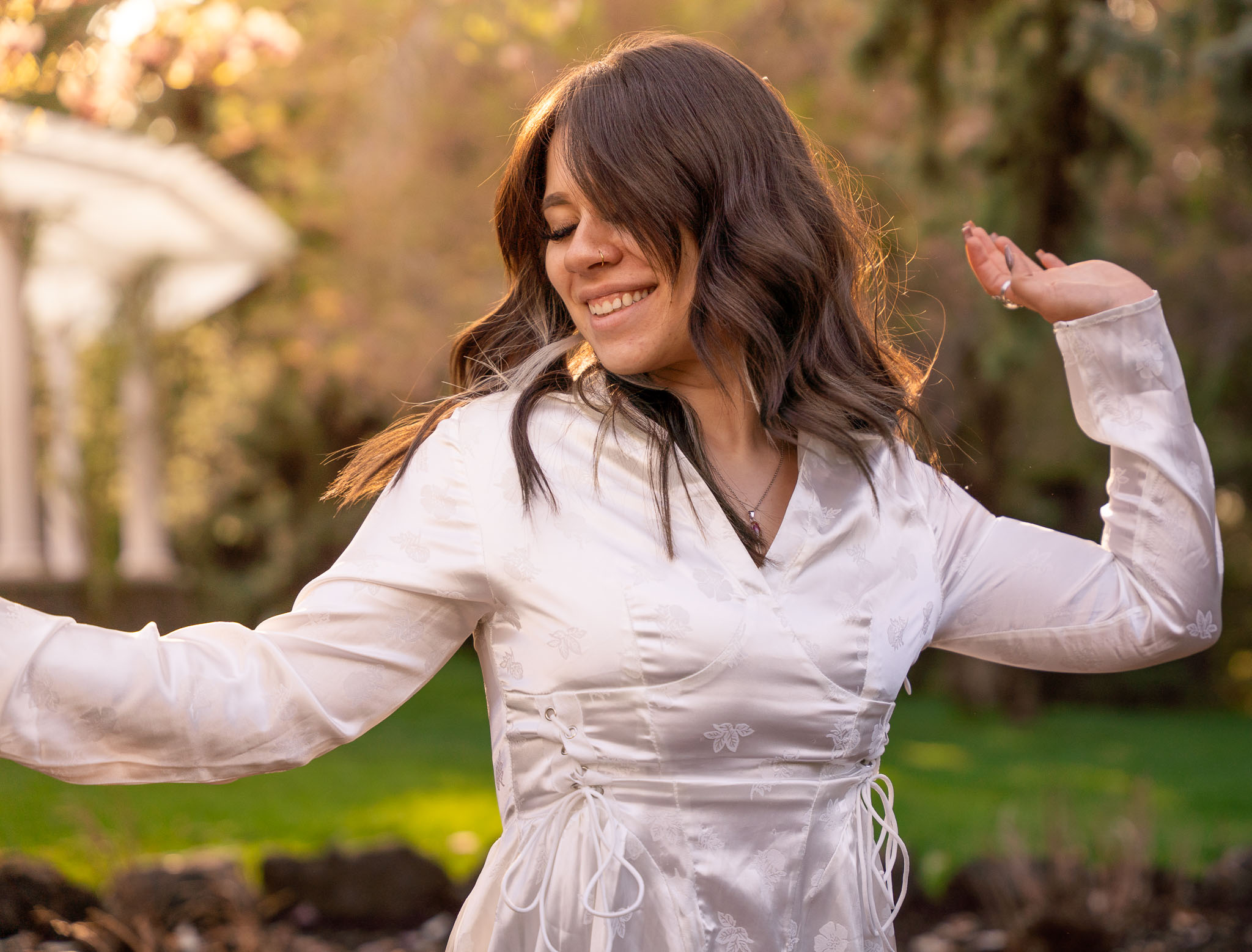 A portrait of a woman with her hands extended outward dancing