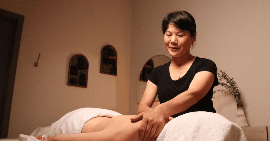 women getting a shoulder and back massage in a dim clinic room
