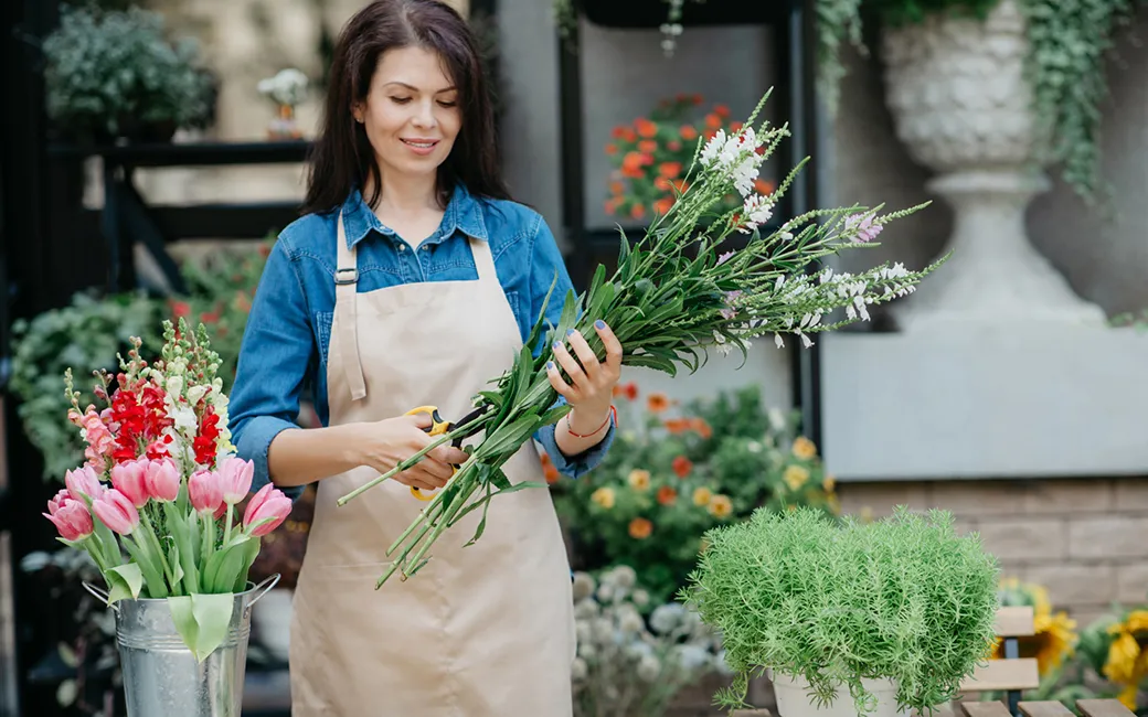 Front view of a woman arranging flowers