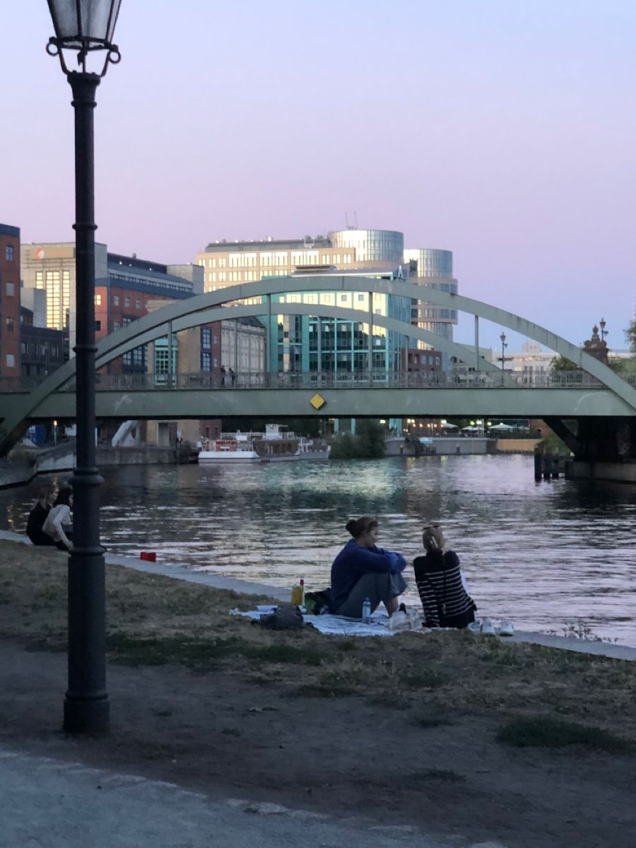 two people sitting at a table with laptops