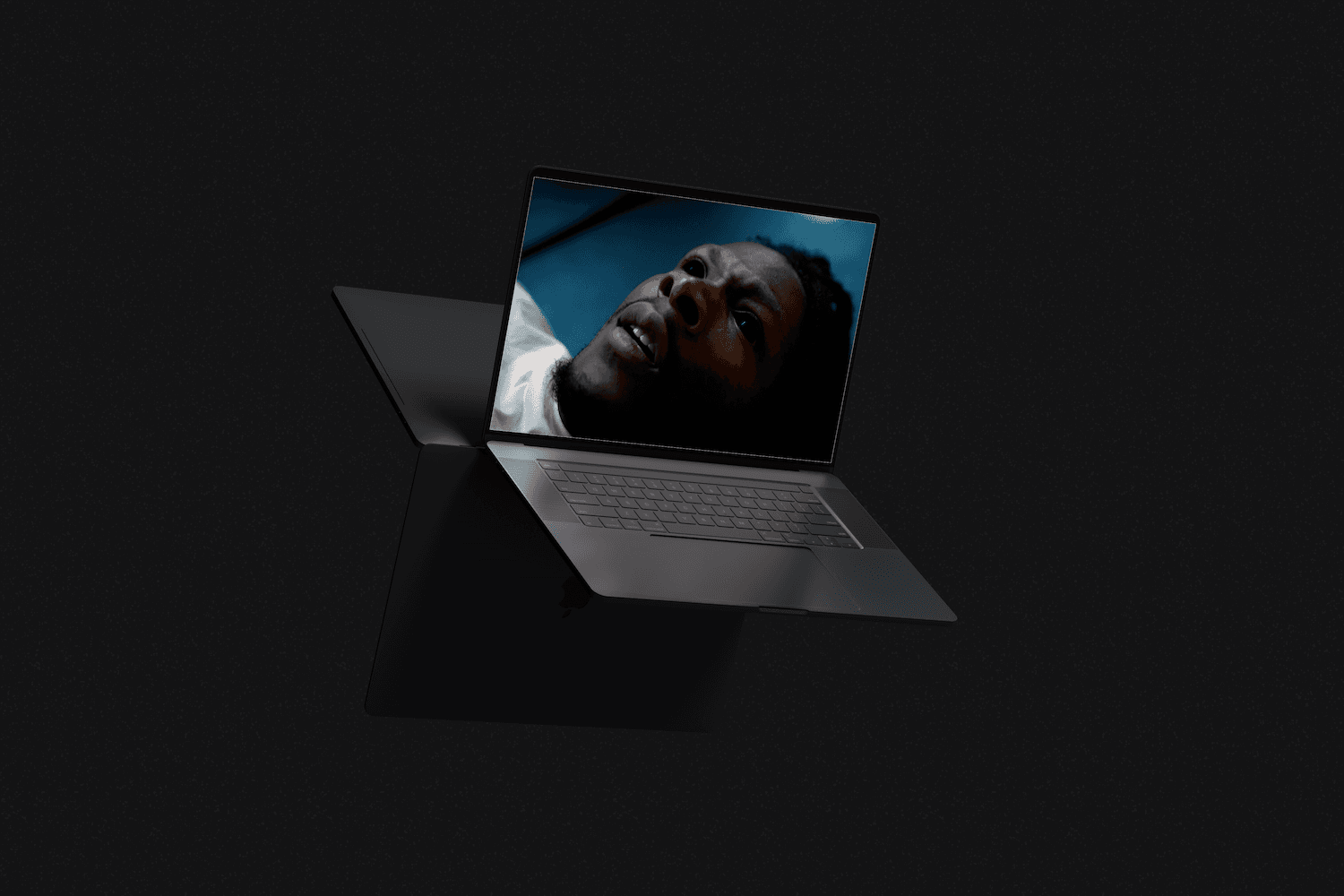 a floating laptop in a dark studio setting showcasing a website