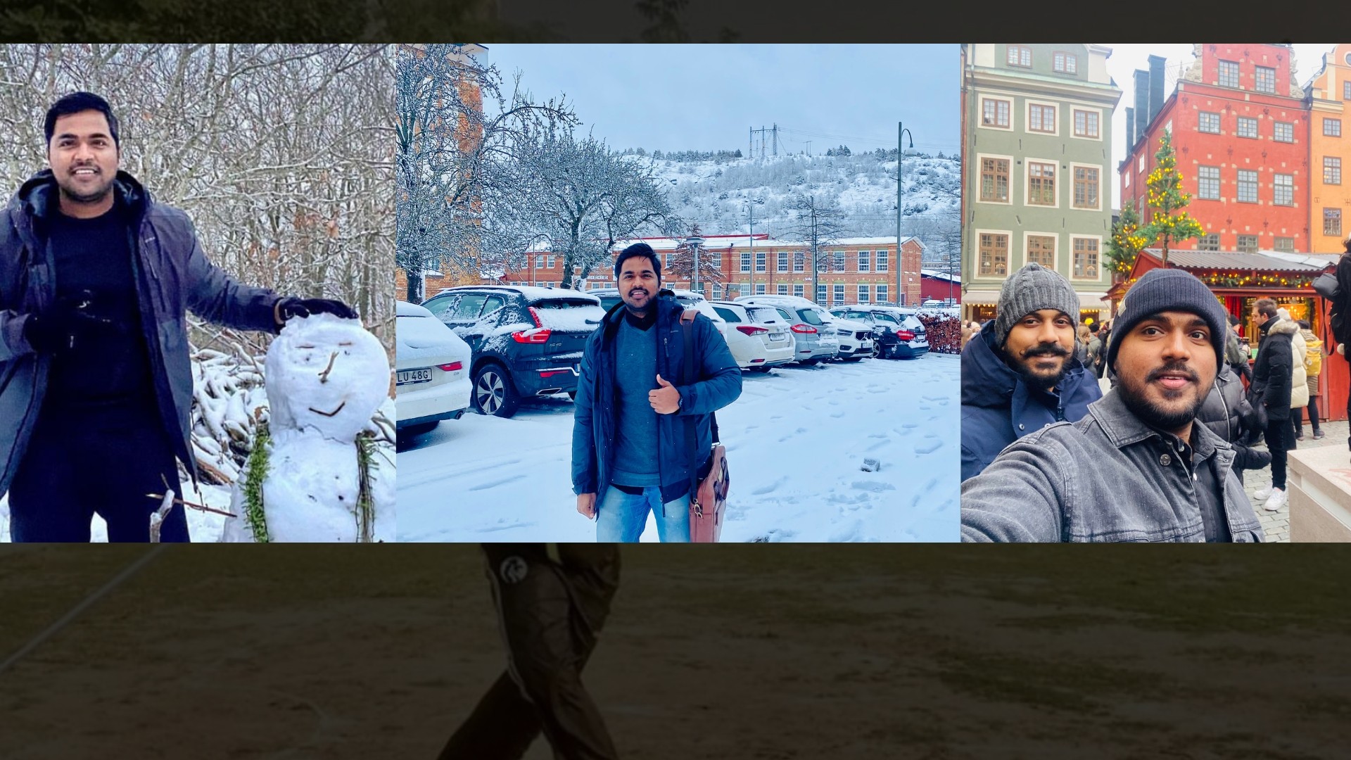 A man stands while two people sit at a table in an office setting, smiling and engaged in conversation. The mood is friendly and collaborative.