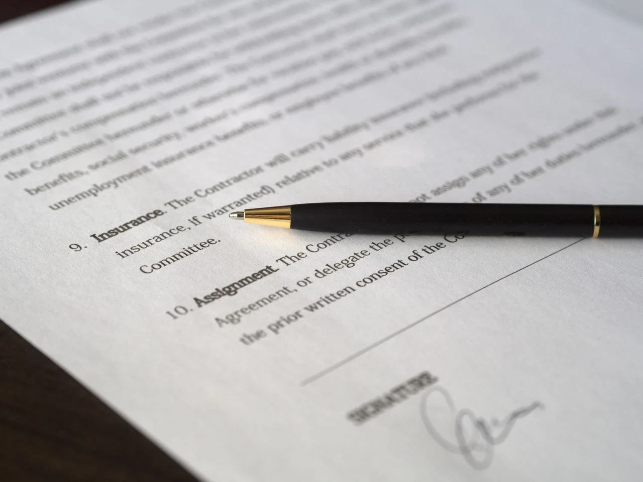 photo d'un contraat signé avec un stylo posé dessus