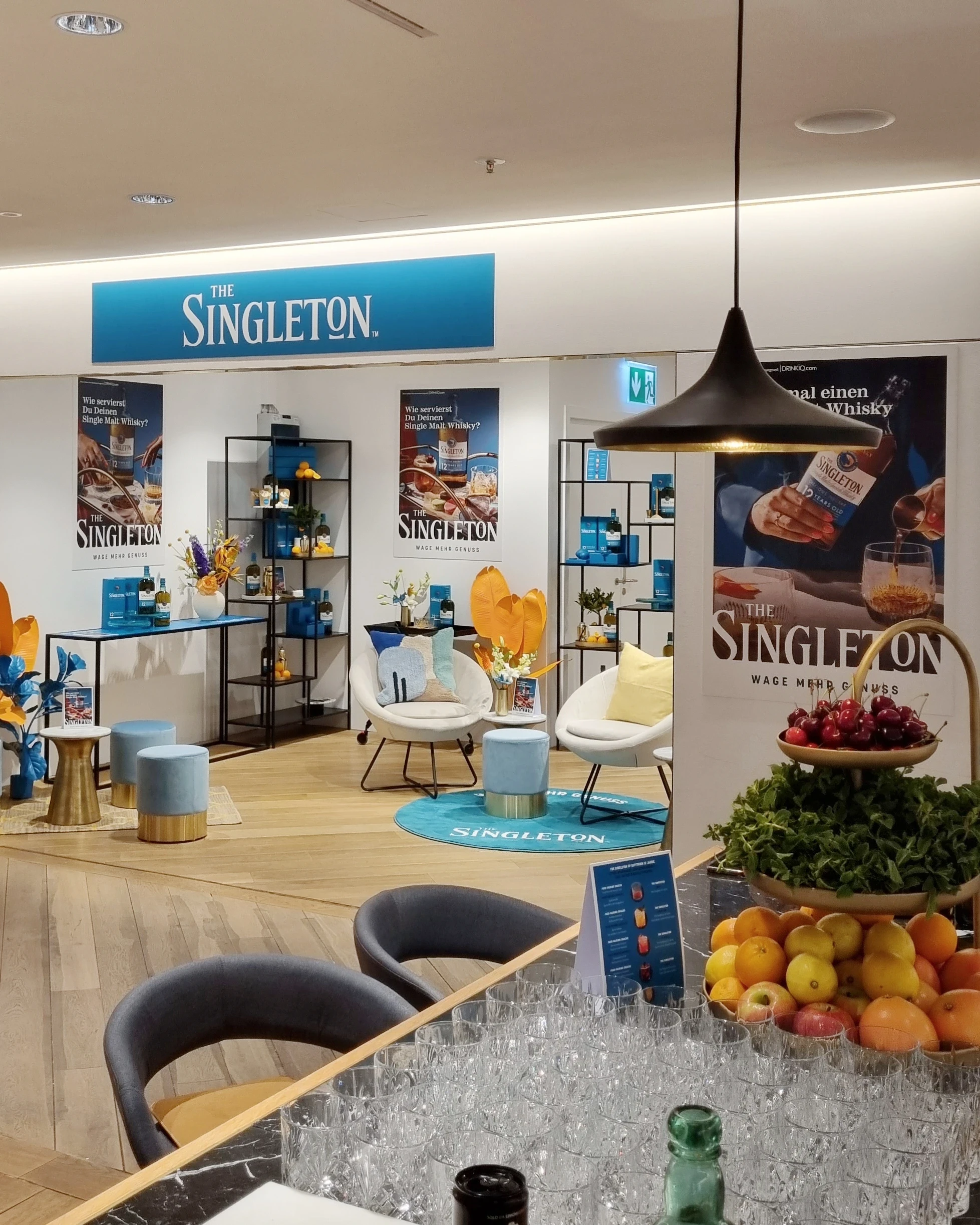 View across the Singleton pop-up with bar, fruit baskets, glasses and seating areas.