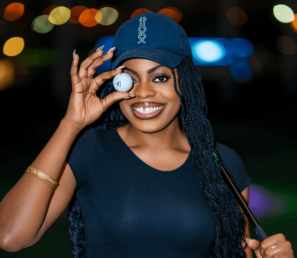 A stunning birthday photoshoot of a beautiful woman at Topgolf Dubai, capturing her celebrating in style with vibrant lights, a lively atmosphere, and elegant poses.