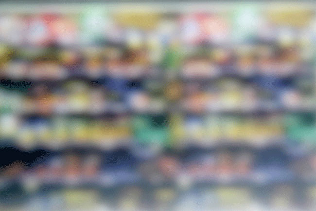 The image is heavily blurred, making it difficult to discern any specific details or objects. The colors are muted and blended together, with no clear shapes or patterns visible. The blurring effect obscures any potential text or graphic elements, making it challenging to identify the subject matter.