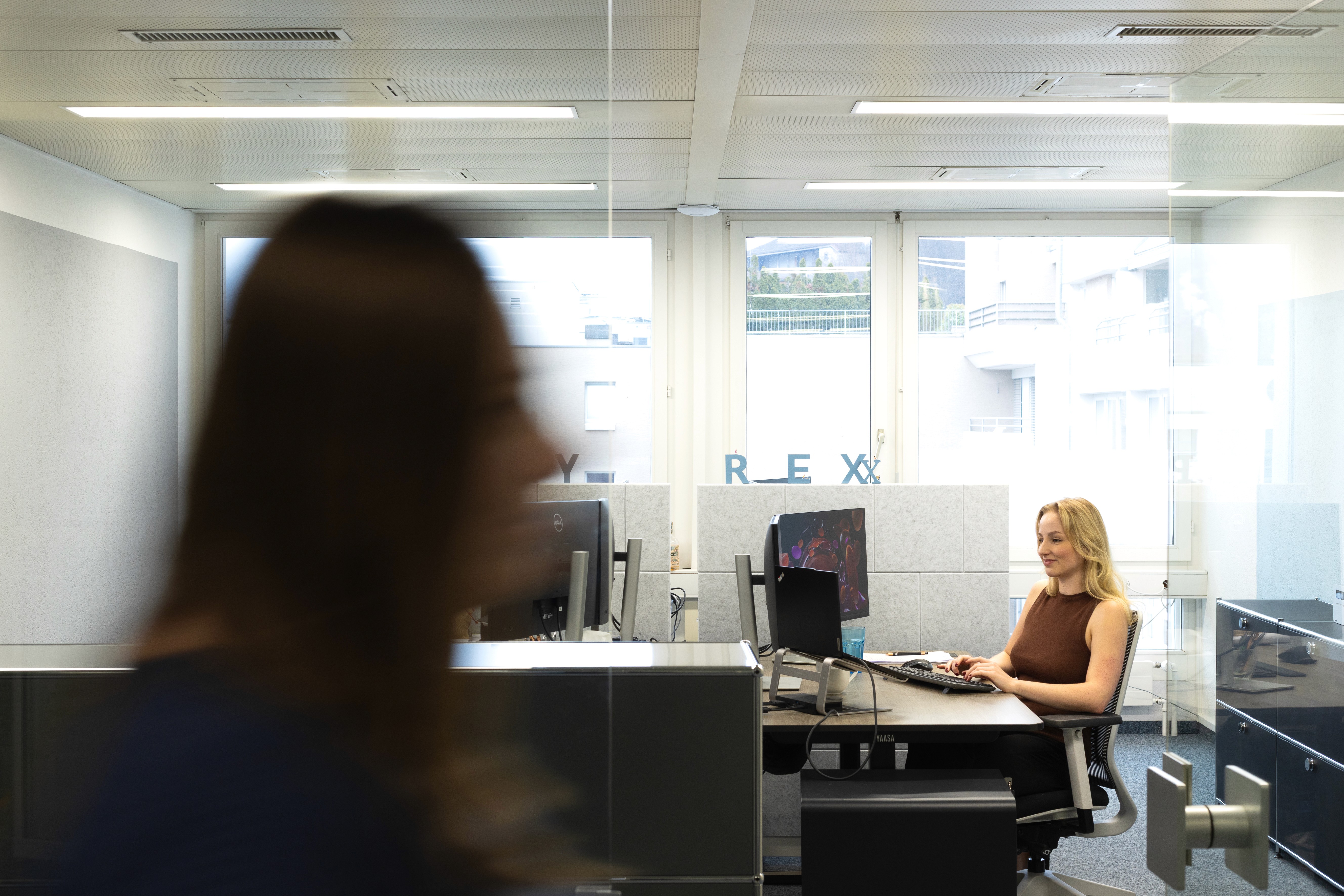 Four business people taking a selfie in an office.