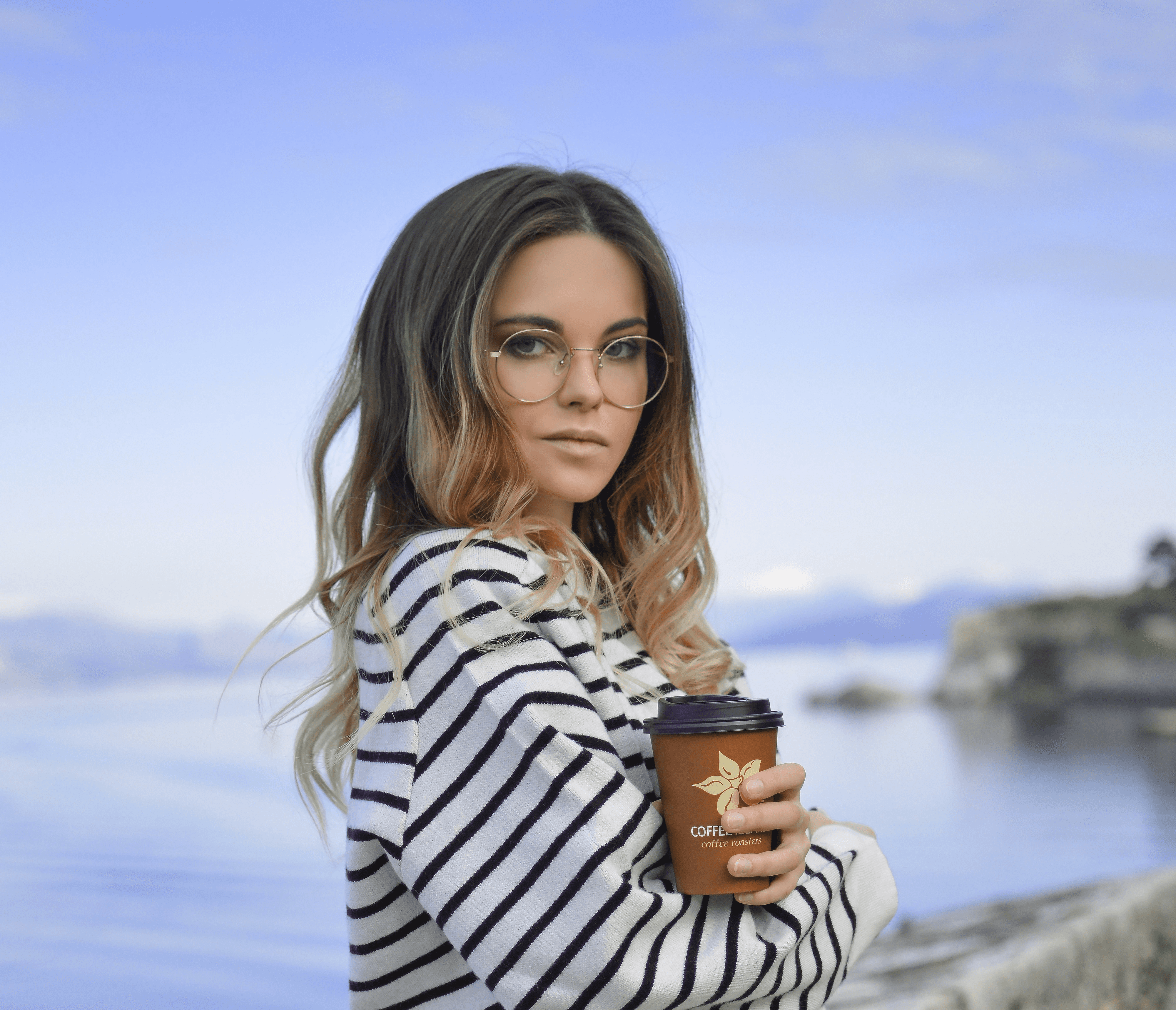 woman in white near calm body of water