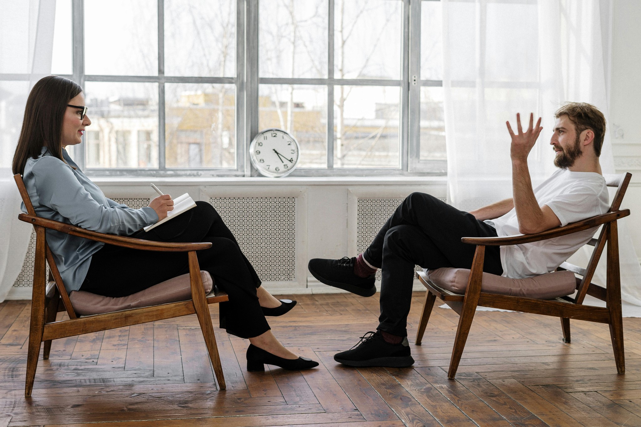 A therapist sitting across from her seated client