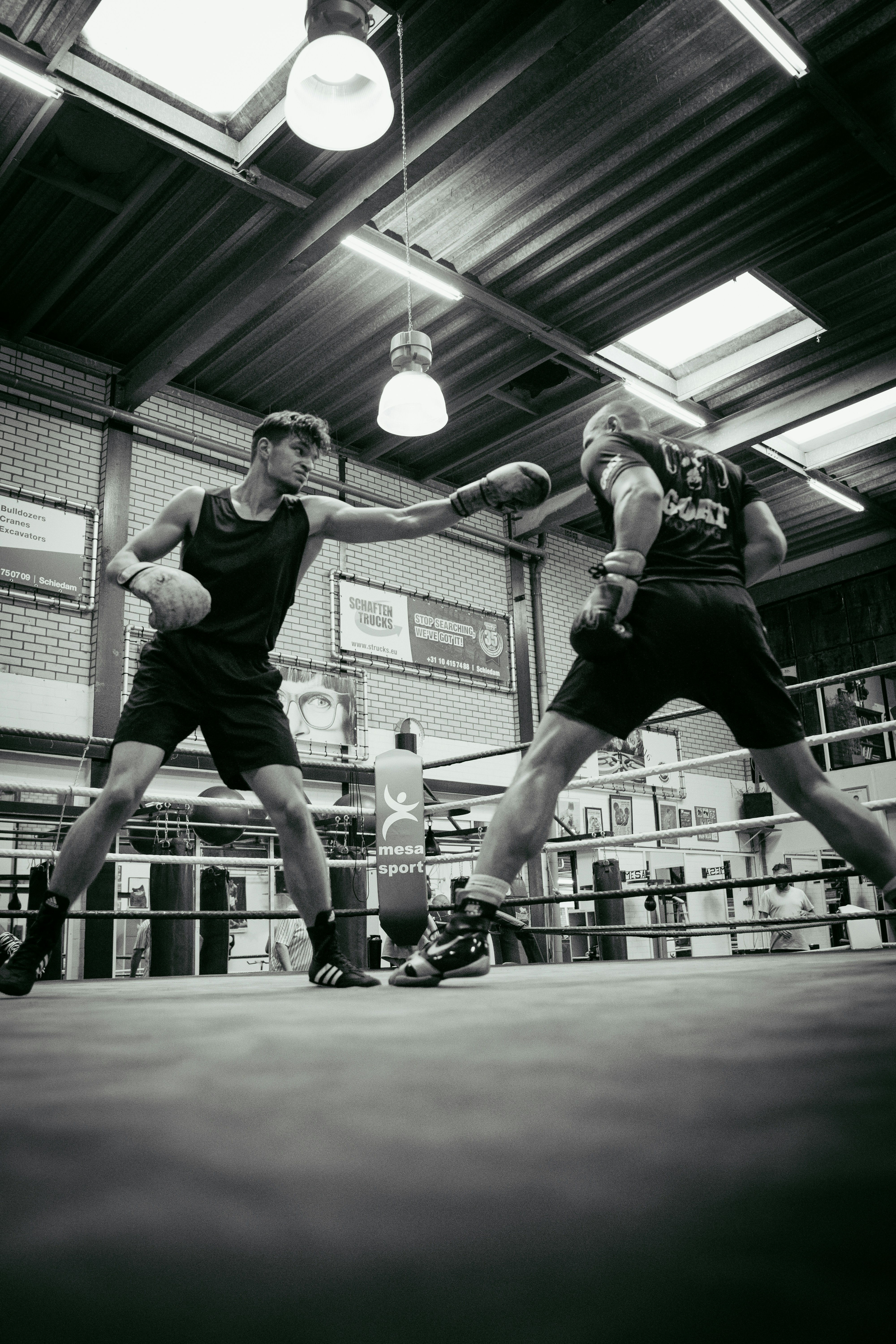 A couple of men standing on top of a boxing ring