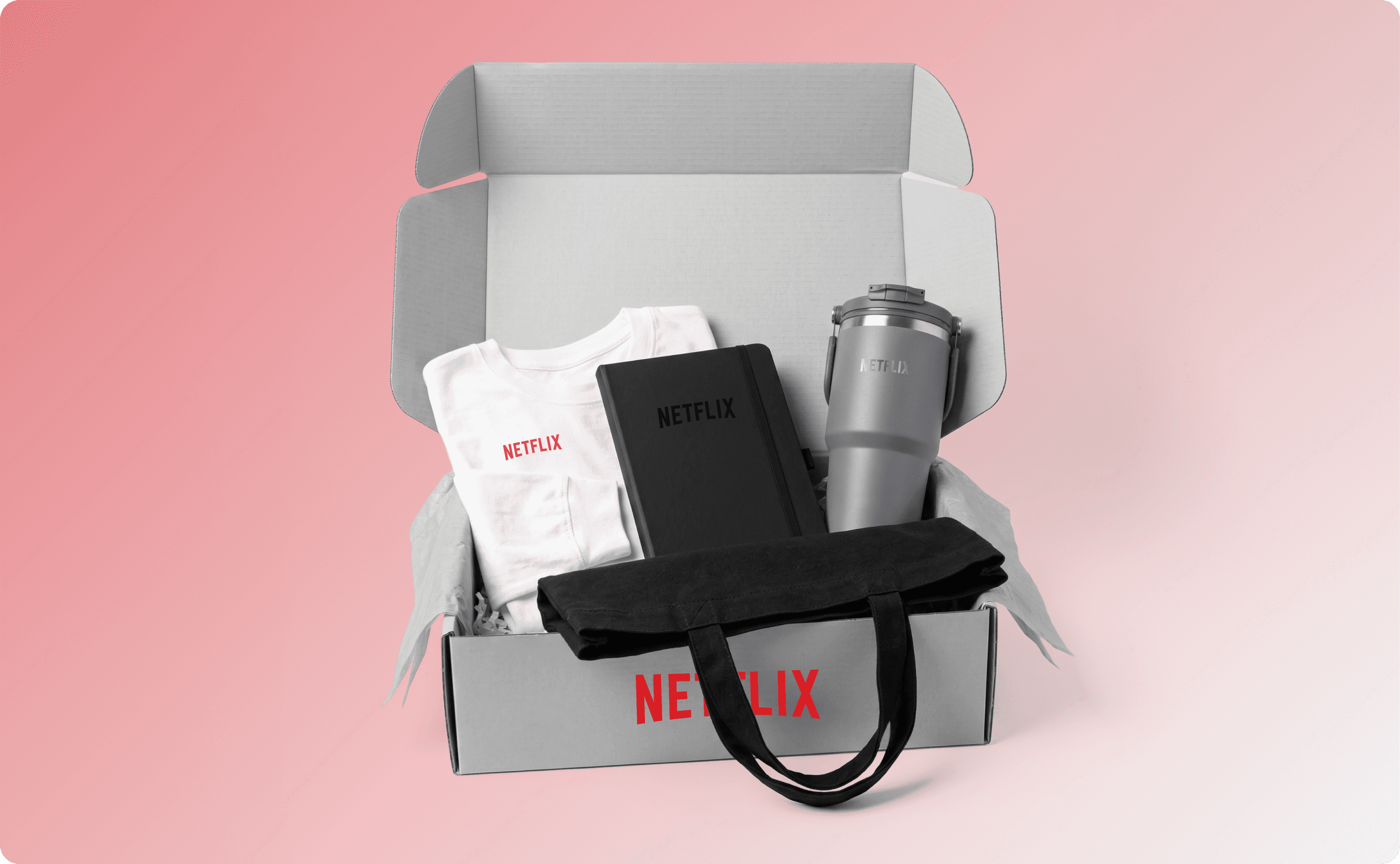 Netflix new hire swag kit that contains an apparel item, a tote bag, a notebook, and a tumbler.