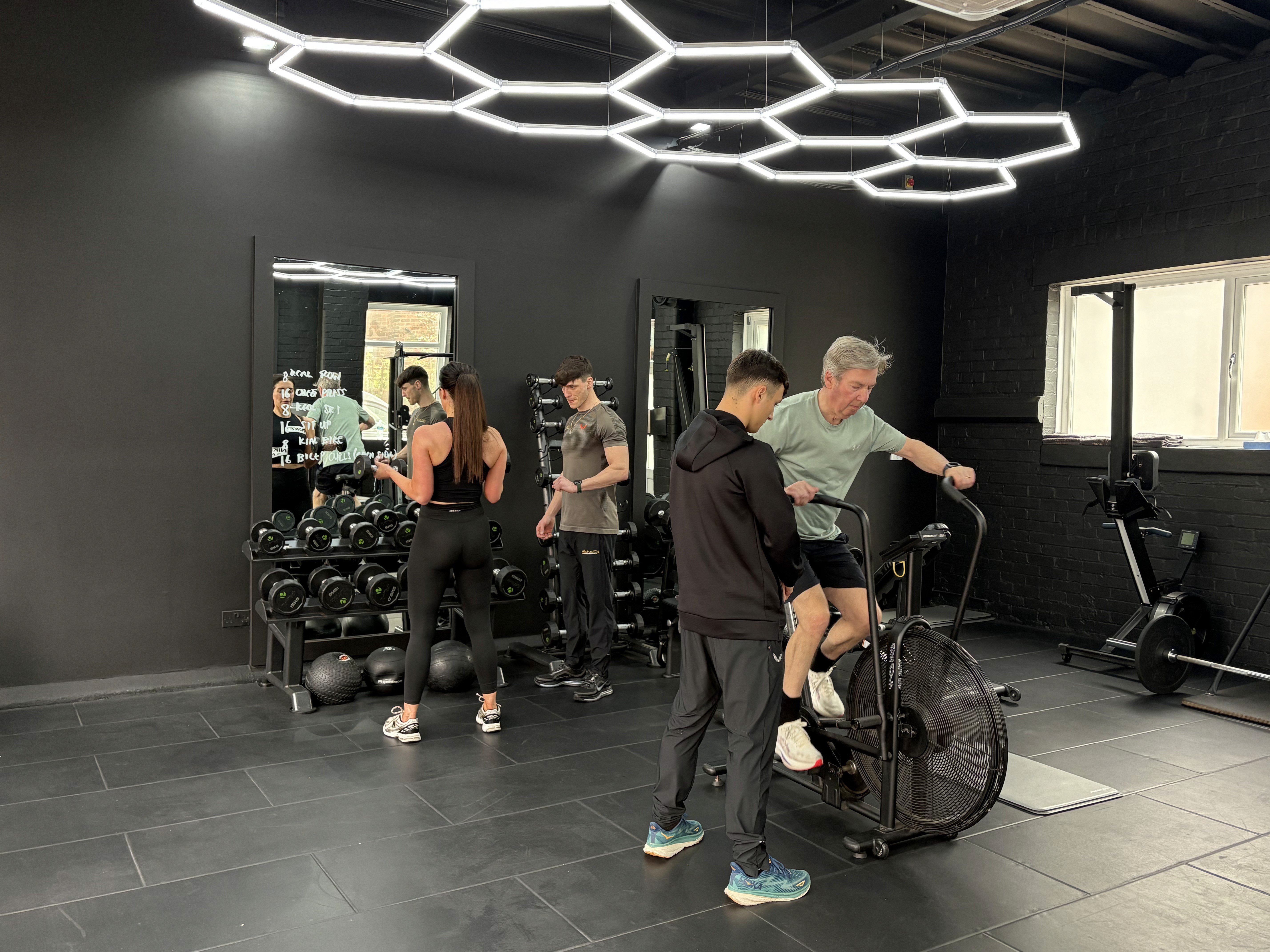 Personal trainers in Wilmslow coaching clients as they do their workouts.