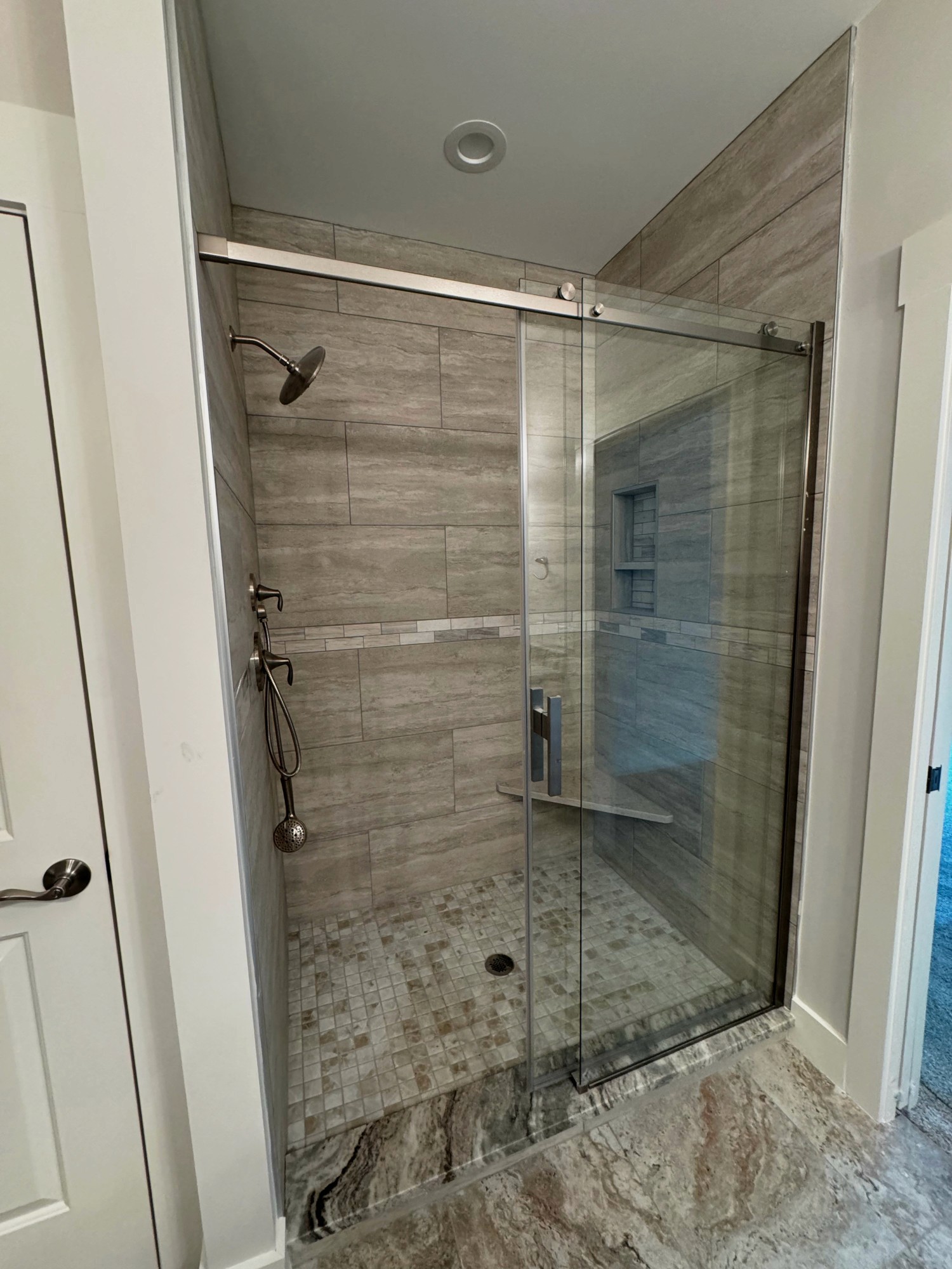 Tile shower with sliding door with seat