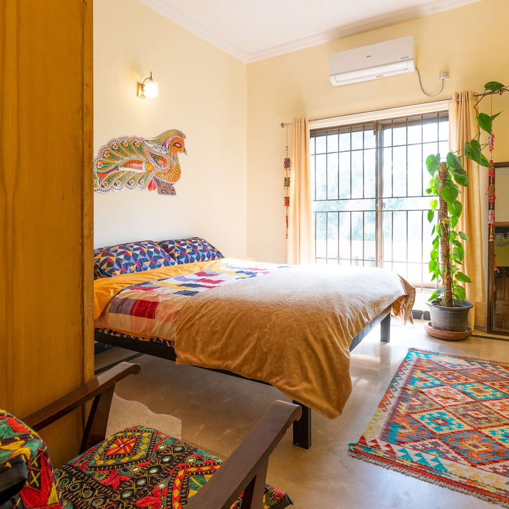 Private room with AC with colorful Pakistani textiles inside Coyote Den Hostel Islamabad in Pakistan