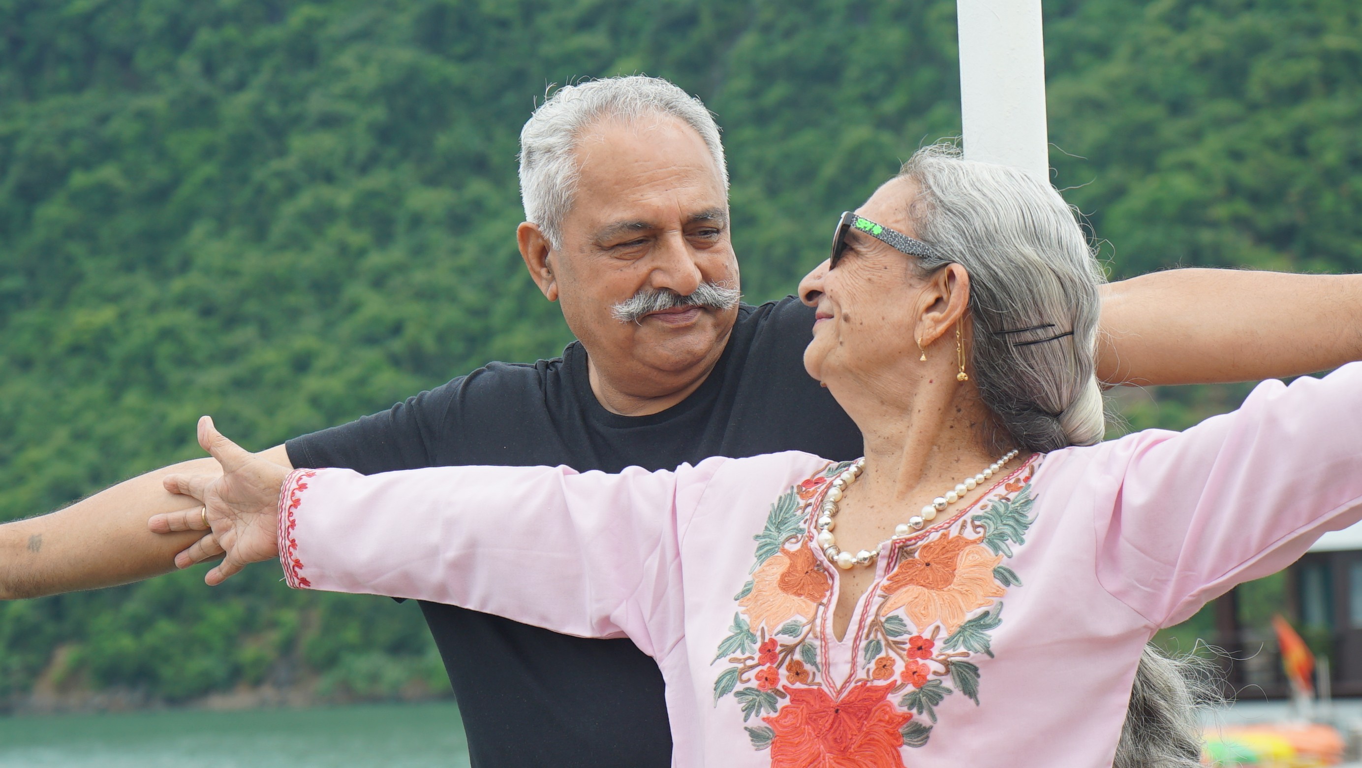 selective focus photo of man standing holding DSLR camera