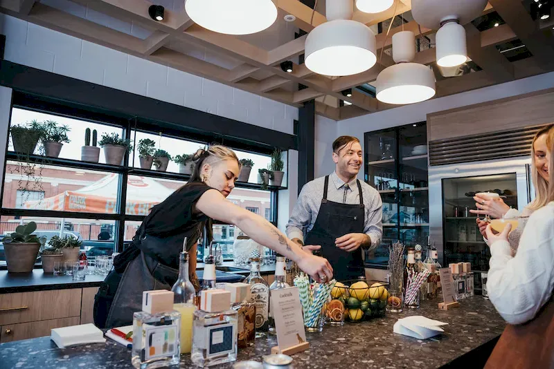 Bartenders working behind a bar
