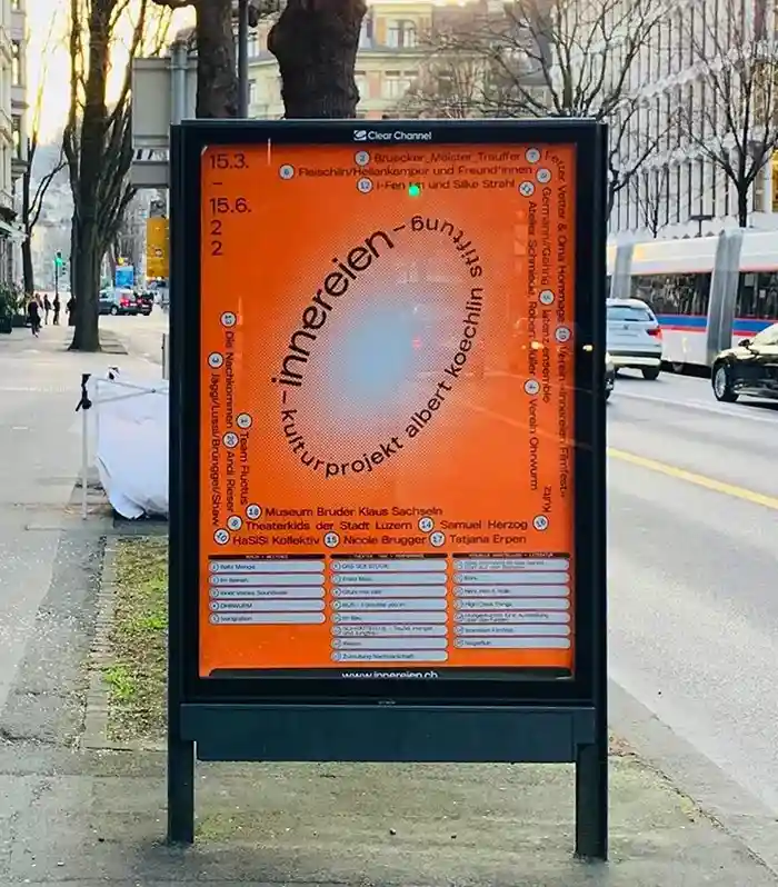 A city poster showing a bright orange typography heavy poster for a event in Switzerland