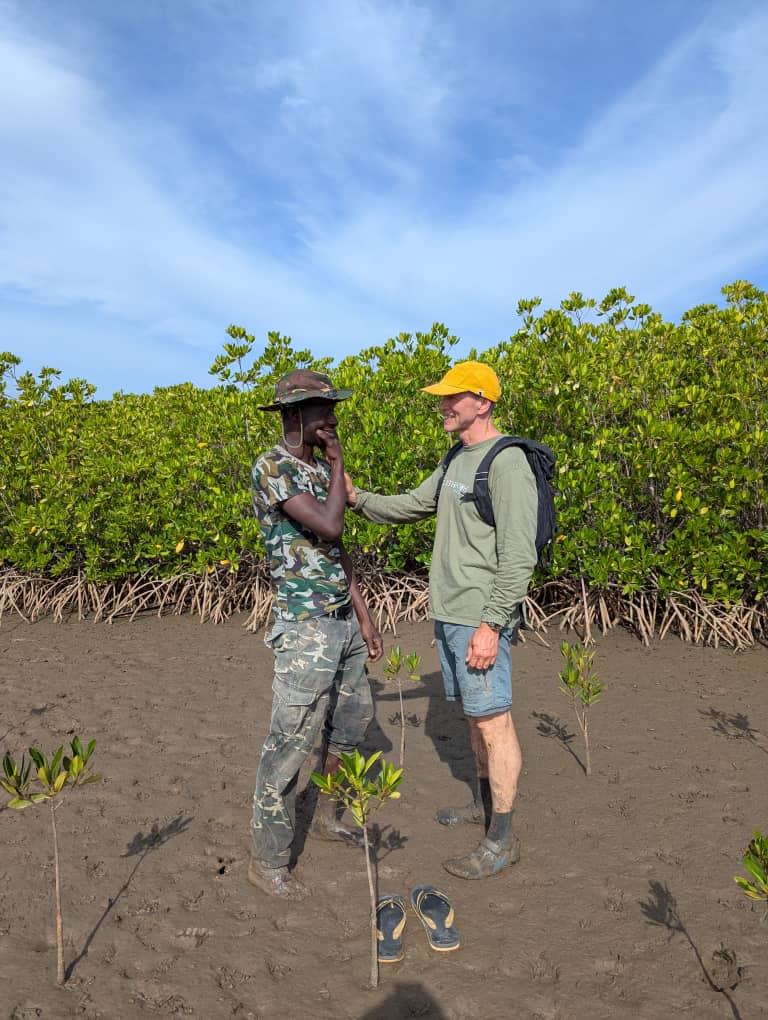 Team members together in mangroves. Photo credit ACES