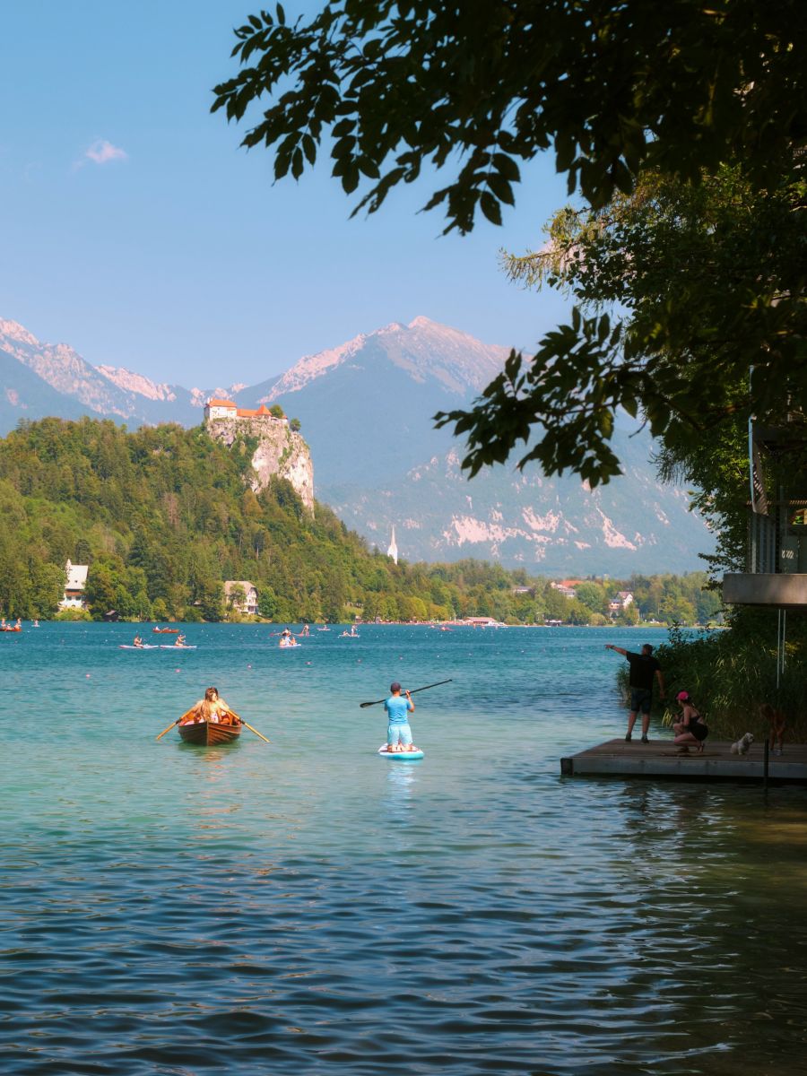 three brown wooden boat on blue lake water taken at daytime