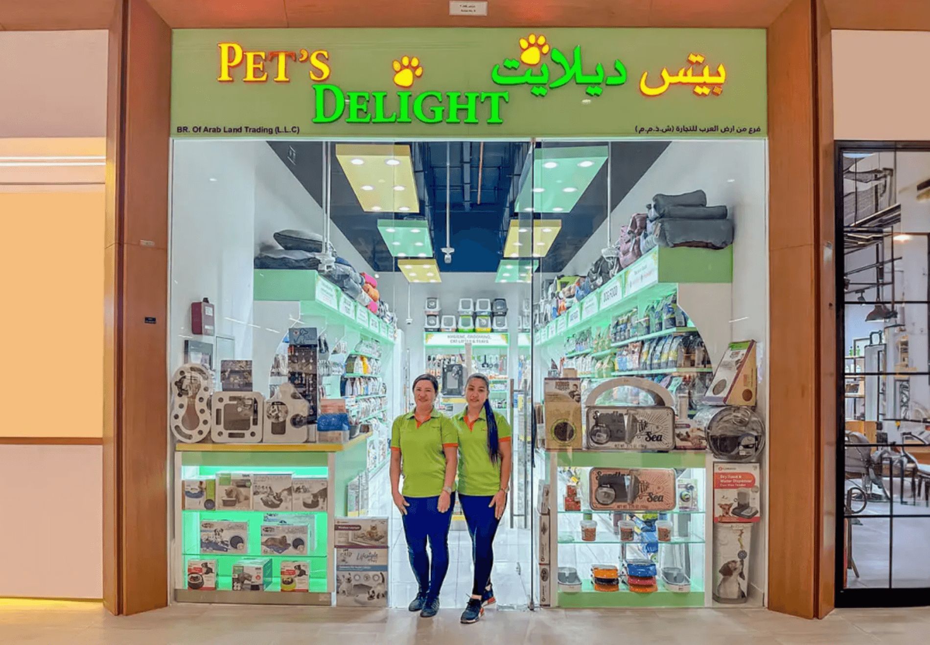 The front view of Pet’s Delight, with glass windows, product displays, and two women at the door.