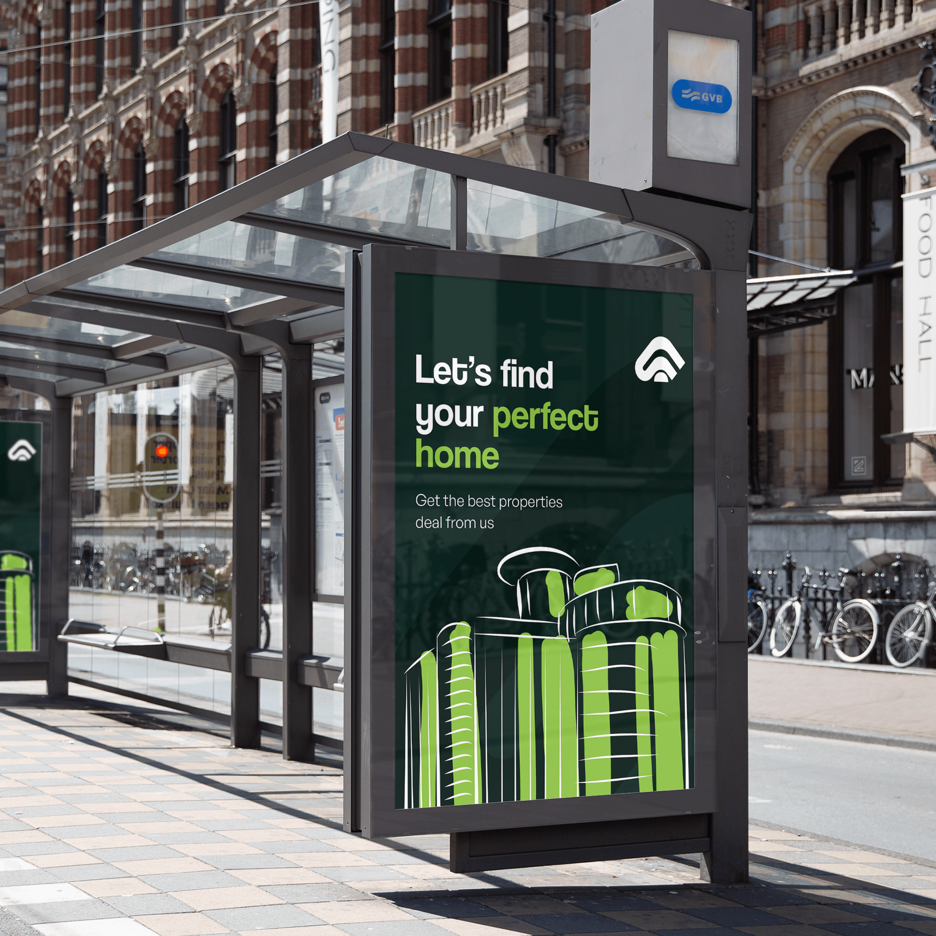 Person wearing black clothing carrying a black tote bag with a green globe-like geometric symbol, standing against a concrete wall in sunlight and shadow.