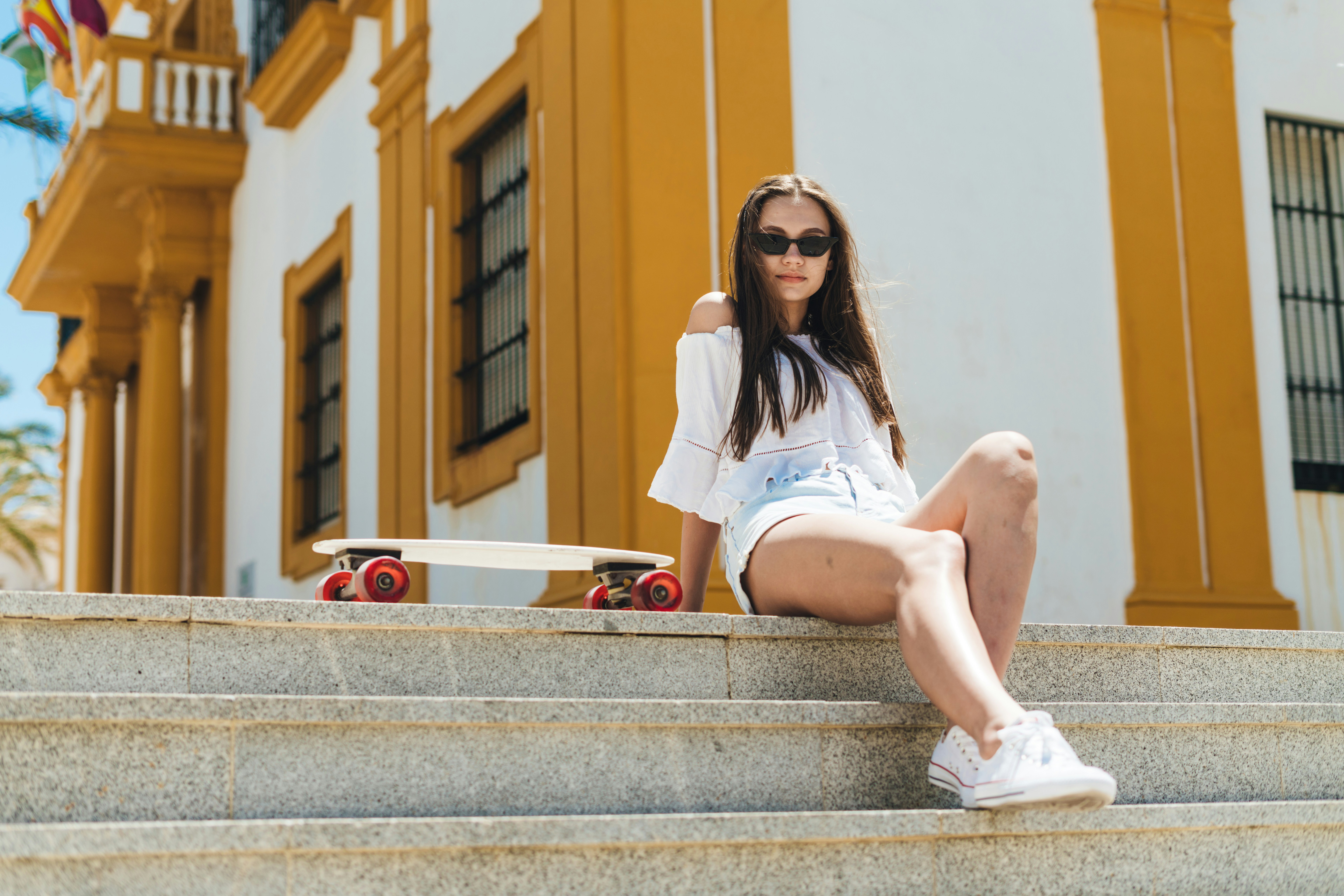 woman sitting on stairs - Preppy Style