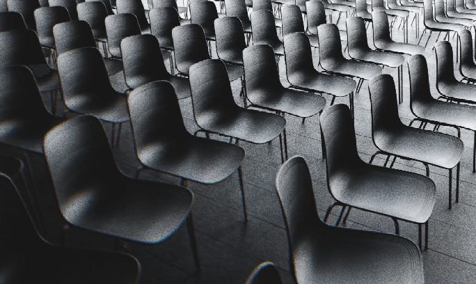 selective focus photography of people sitting on chairs while writing on notebooks