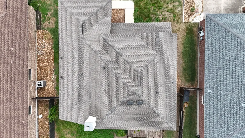 Completed New Braunfels shingle roof replacement viewed from above.